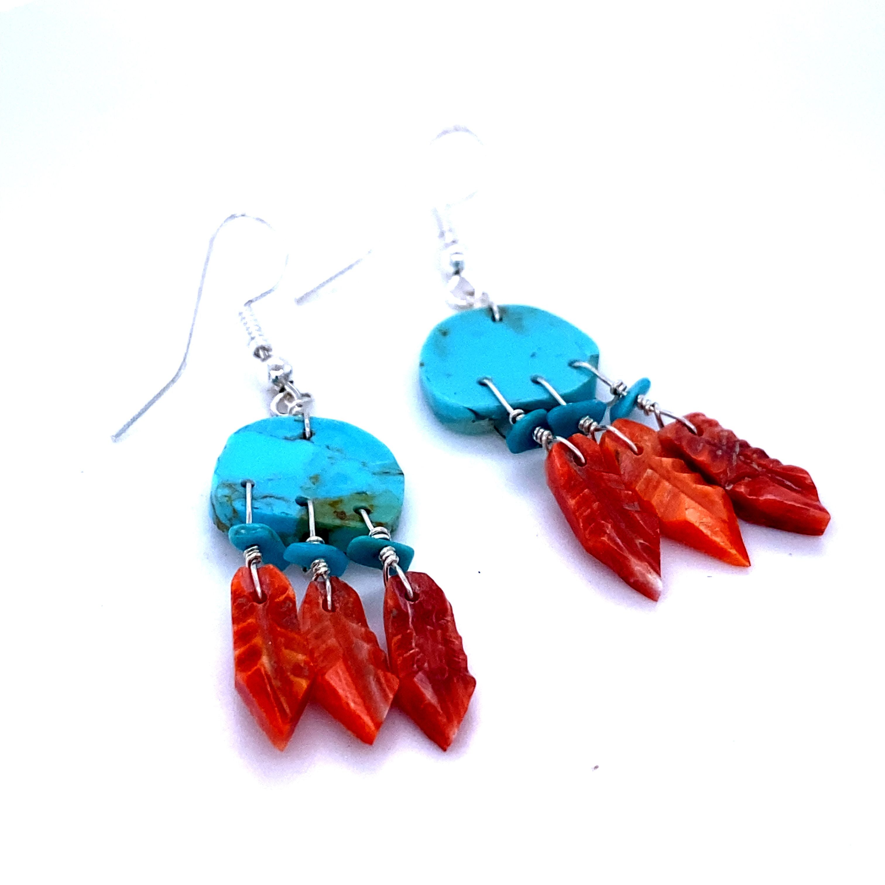 A pair of Handmade Earrings with 3 Small Stone Feathers, inspired by Native American culture, meticulously crafted by artisans, and created by Super Silver brand with vibrant red and orange feathers.