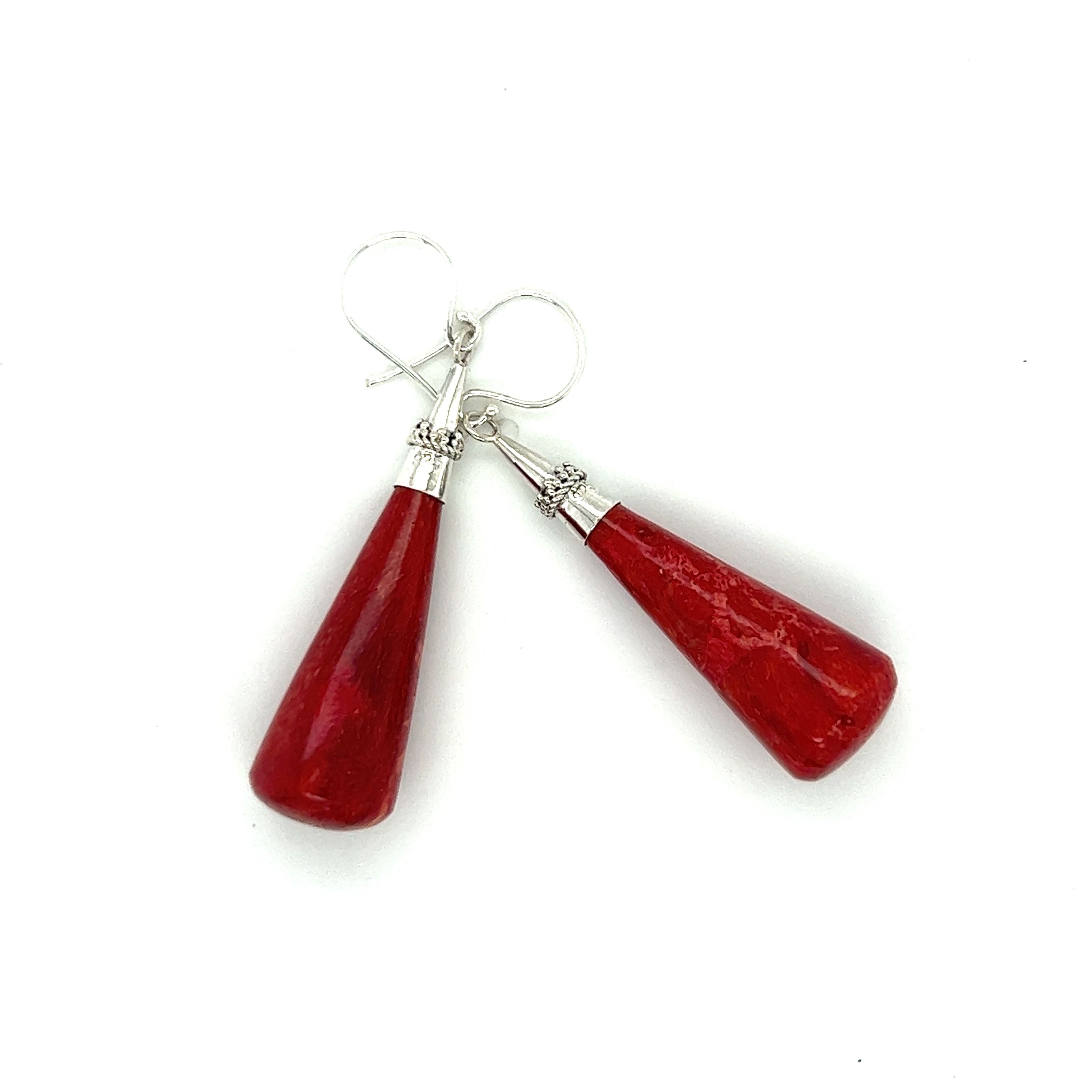 A pair of long sponge coral drop earrings by Super Silver on a white background.