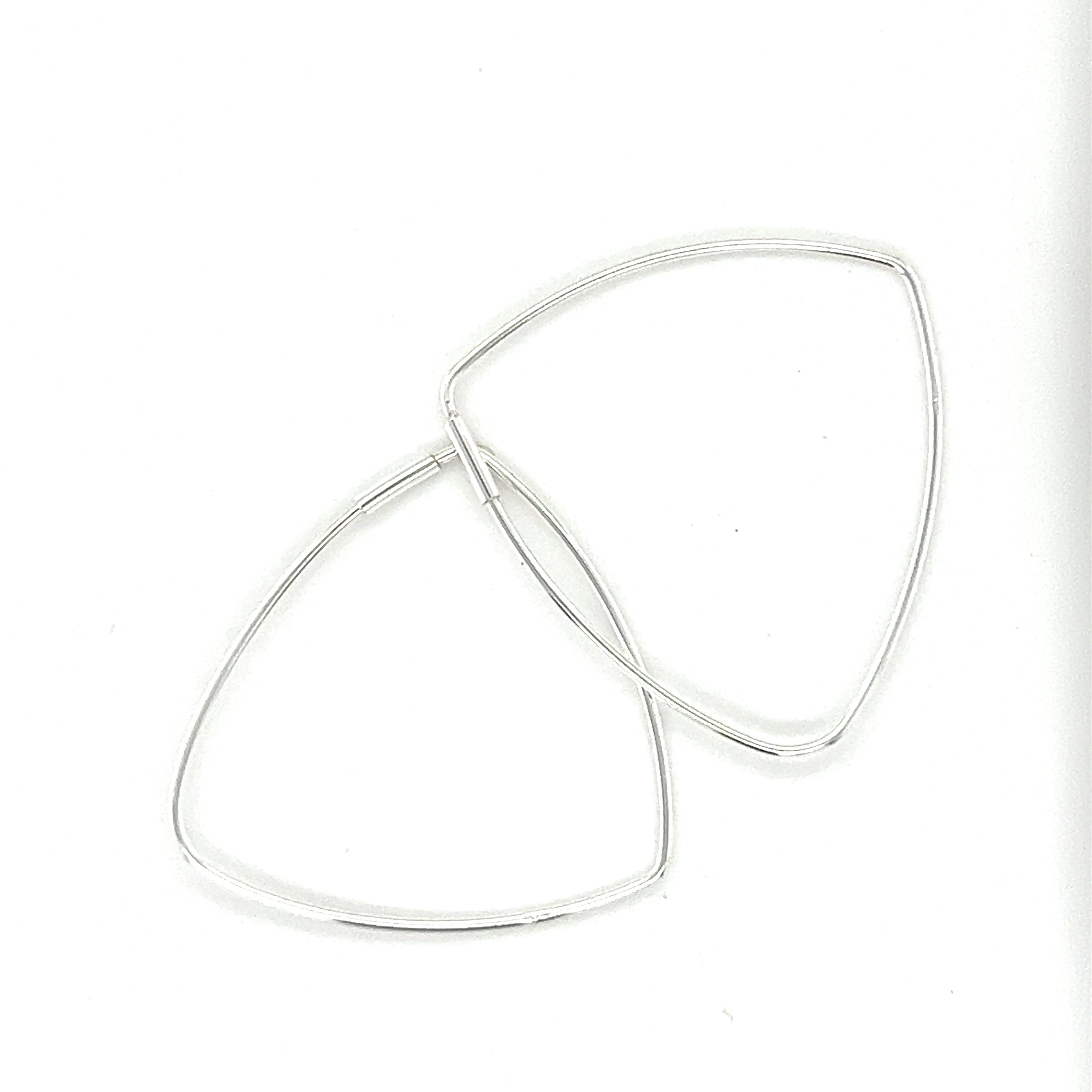 A pair of Delicate Triangle Shaped Hoops by Super Silver on a white surface.