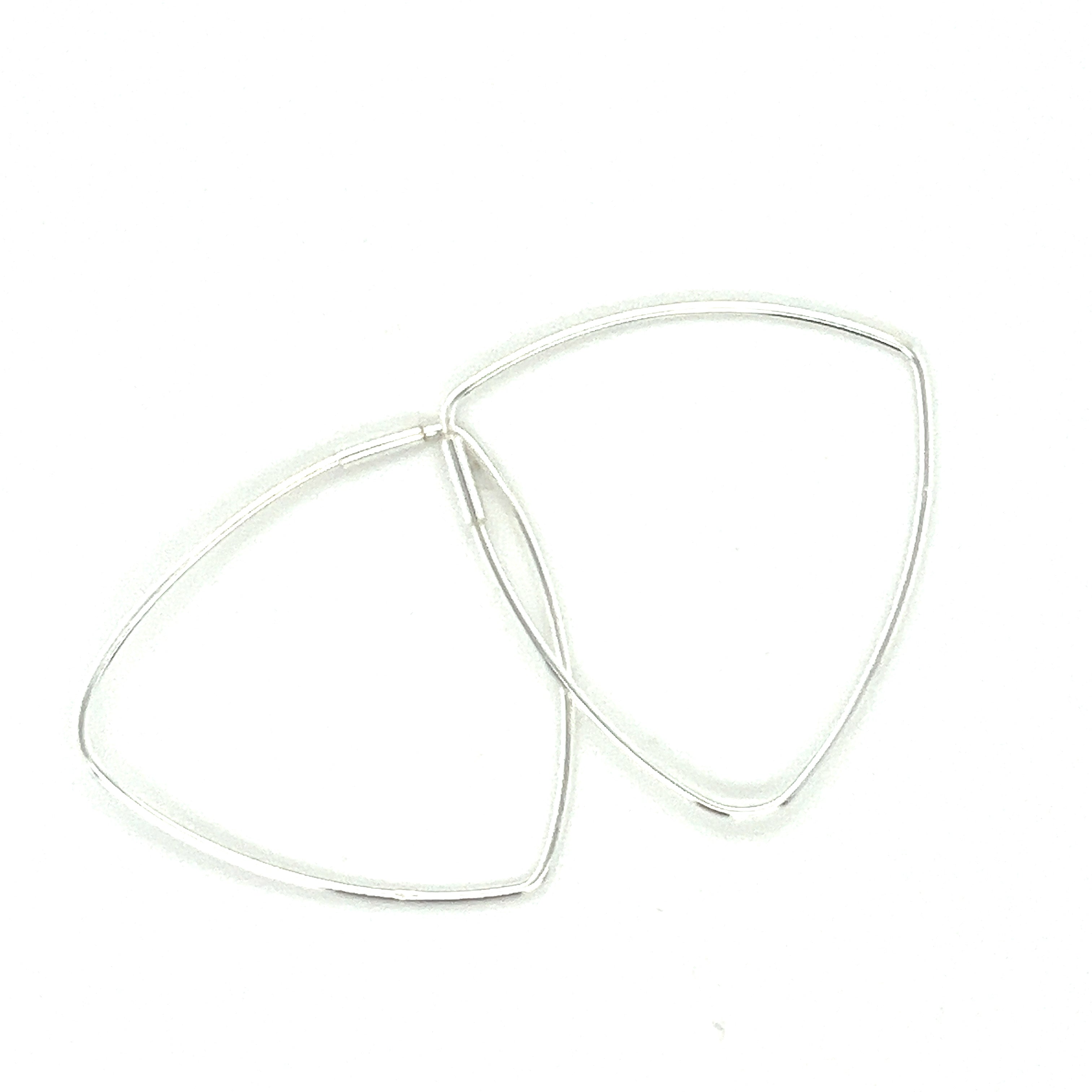 A pair of Super Silver Delicate Triangle Shaped Hoops on a white surface.
