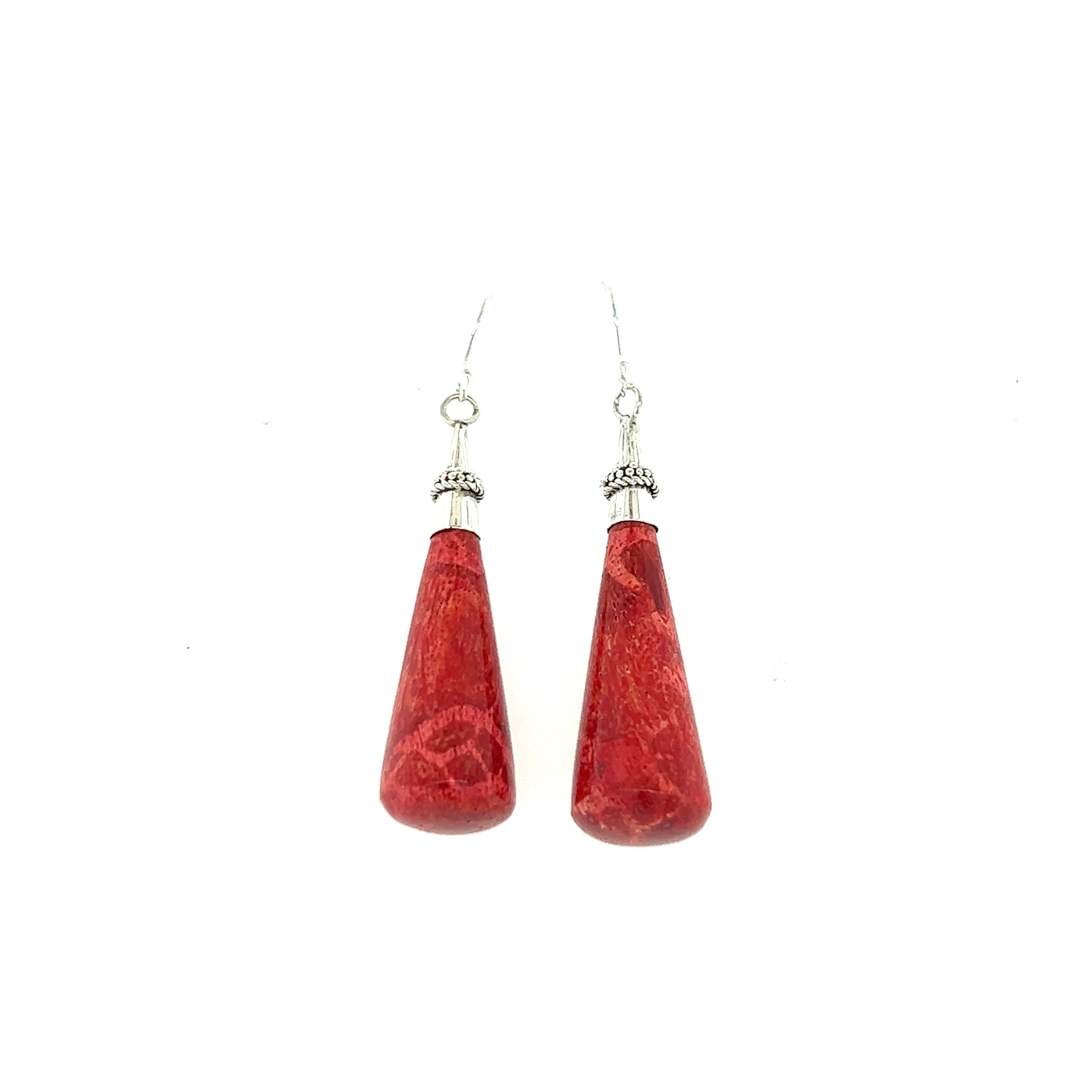 A pair of Super Silver Long Sponge Coral Drop Earrings on a white background, radiating happiness.