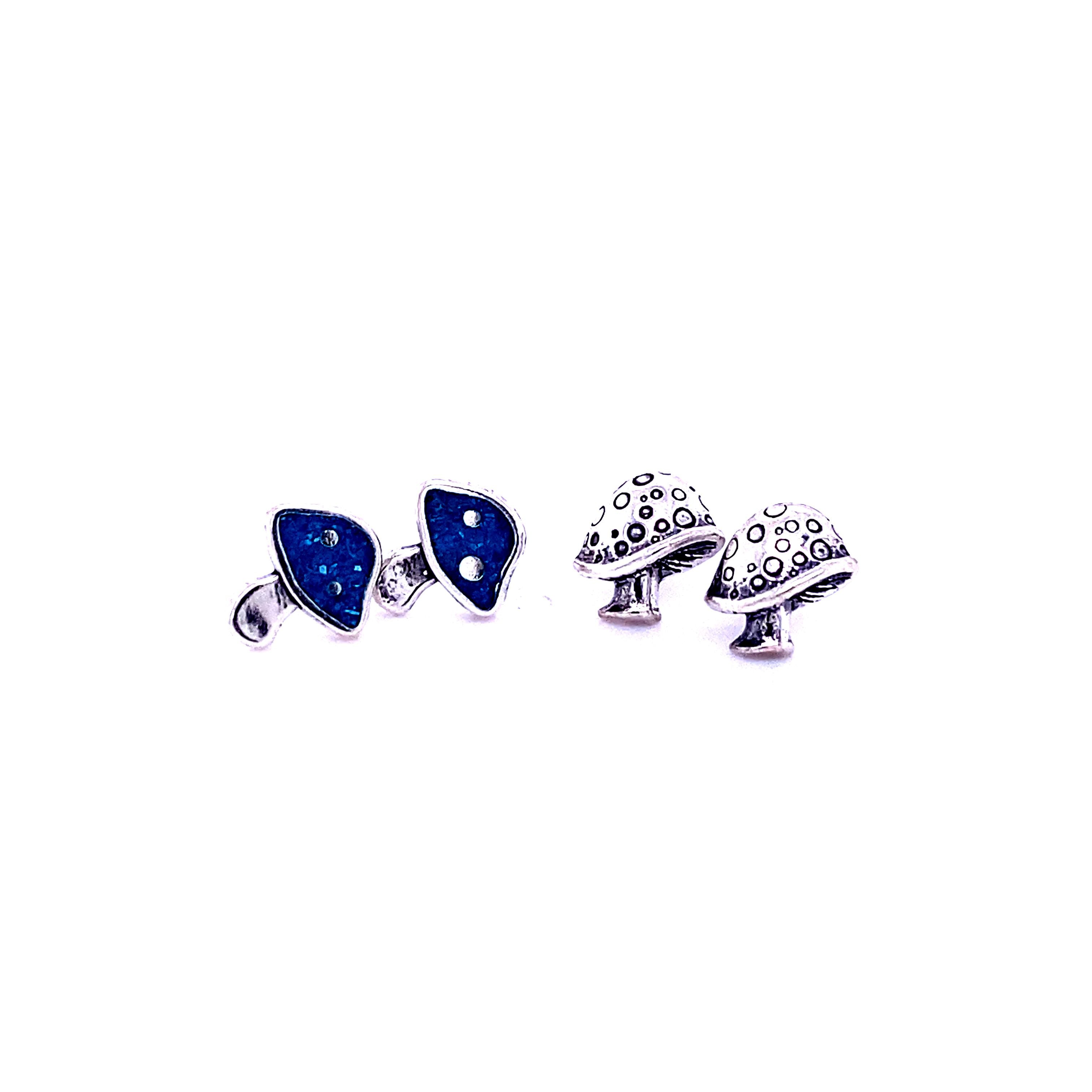 A pair of Mushroom Stud Earrings from Super Silver with blue stones.