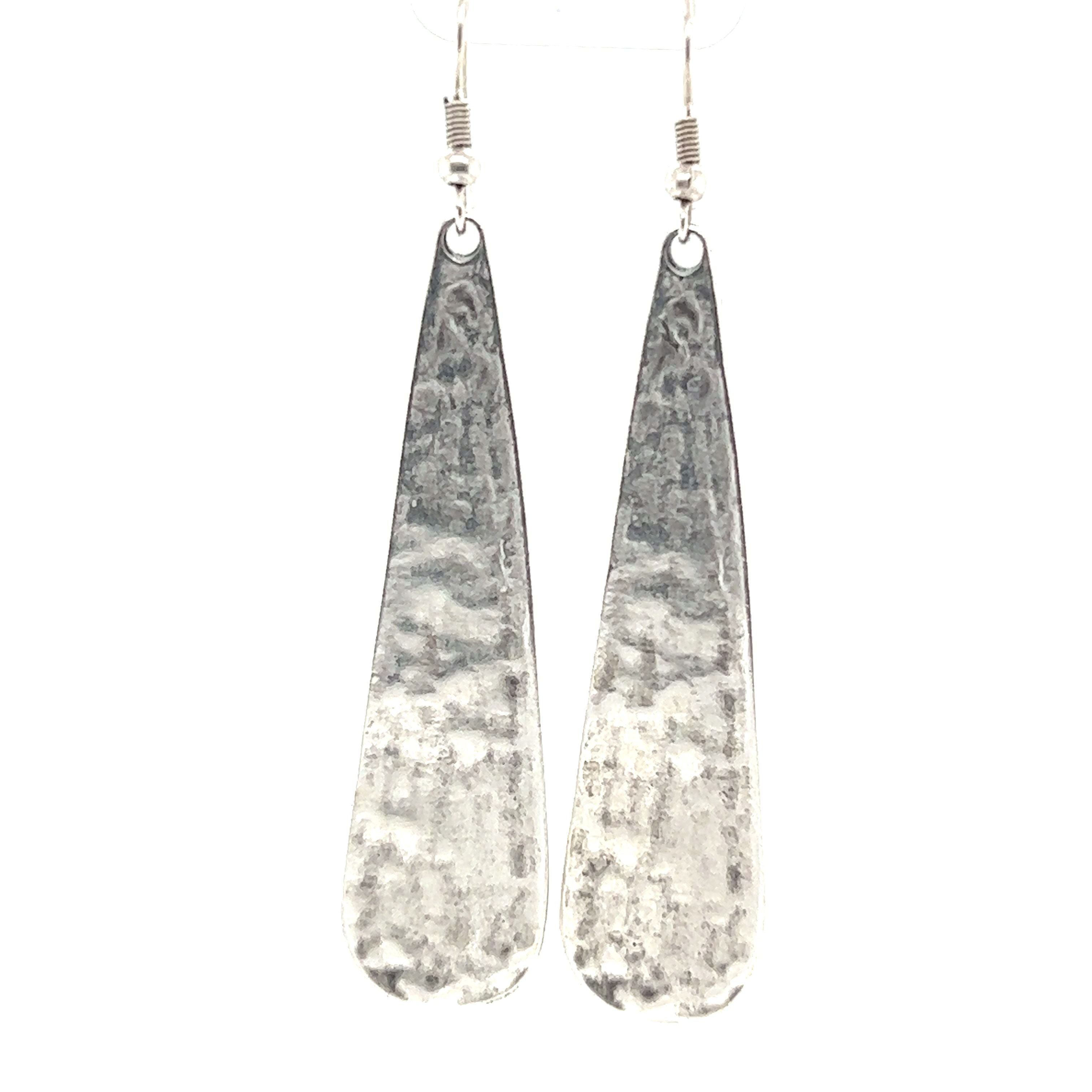 A pair of Super Silver Long Boho Statement Earrings on a white background.