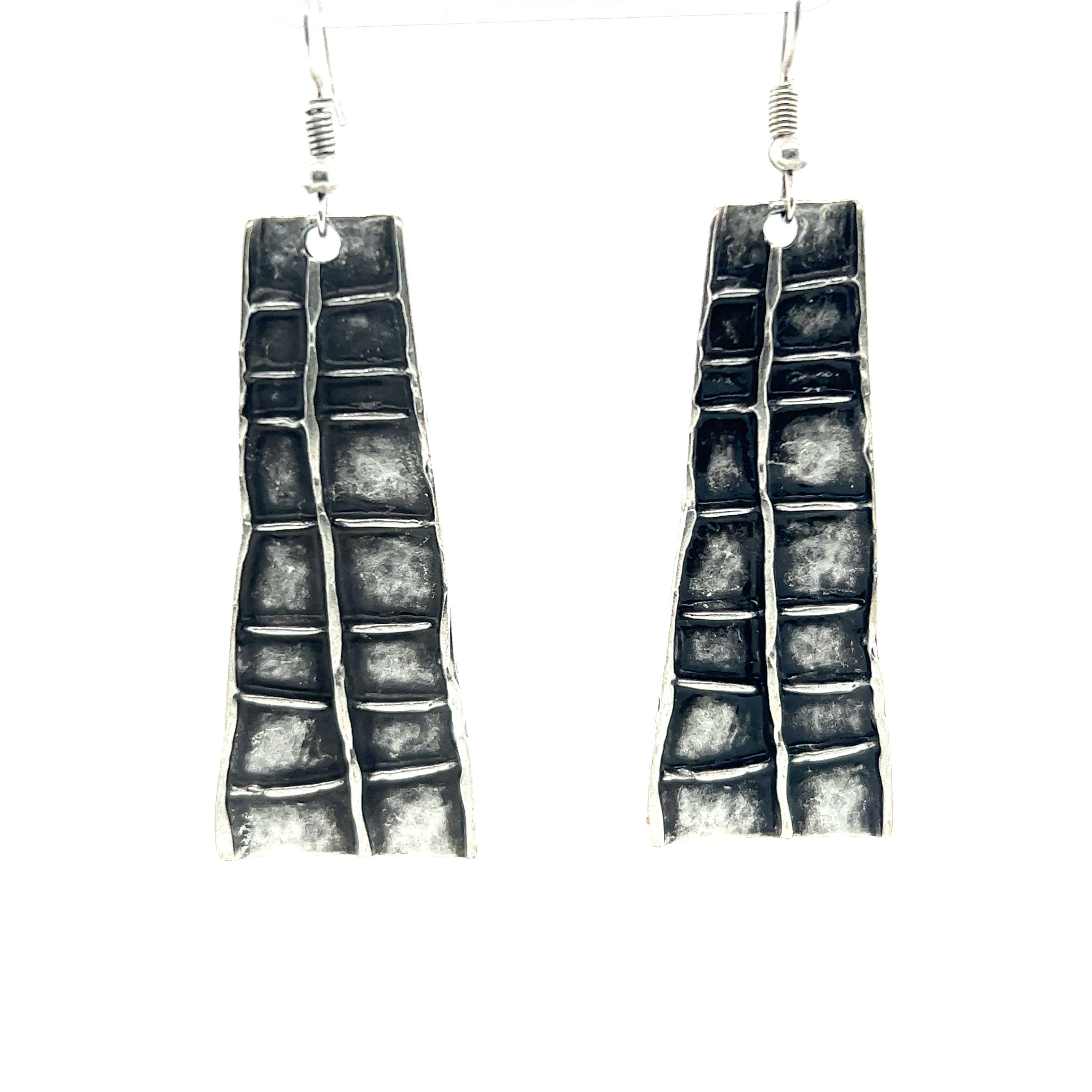A pair of dramatic Super Silver Long Boho Statement Earrings on a white background.