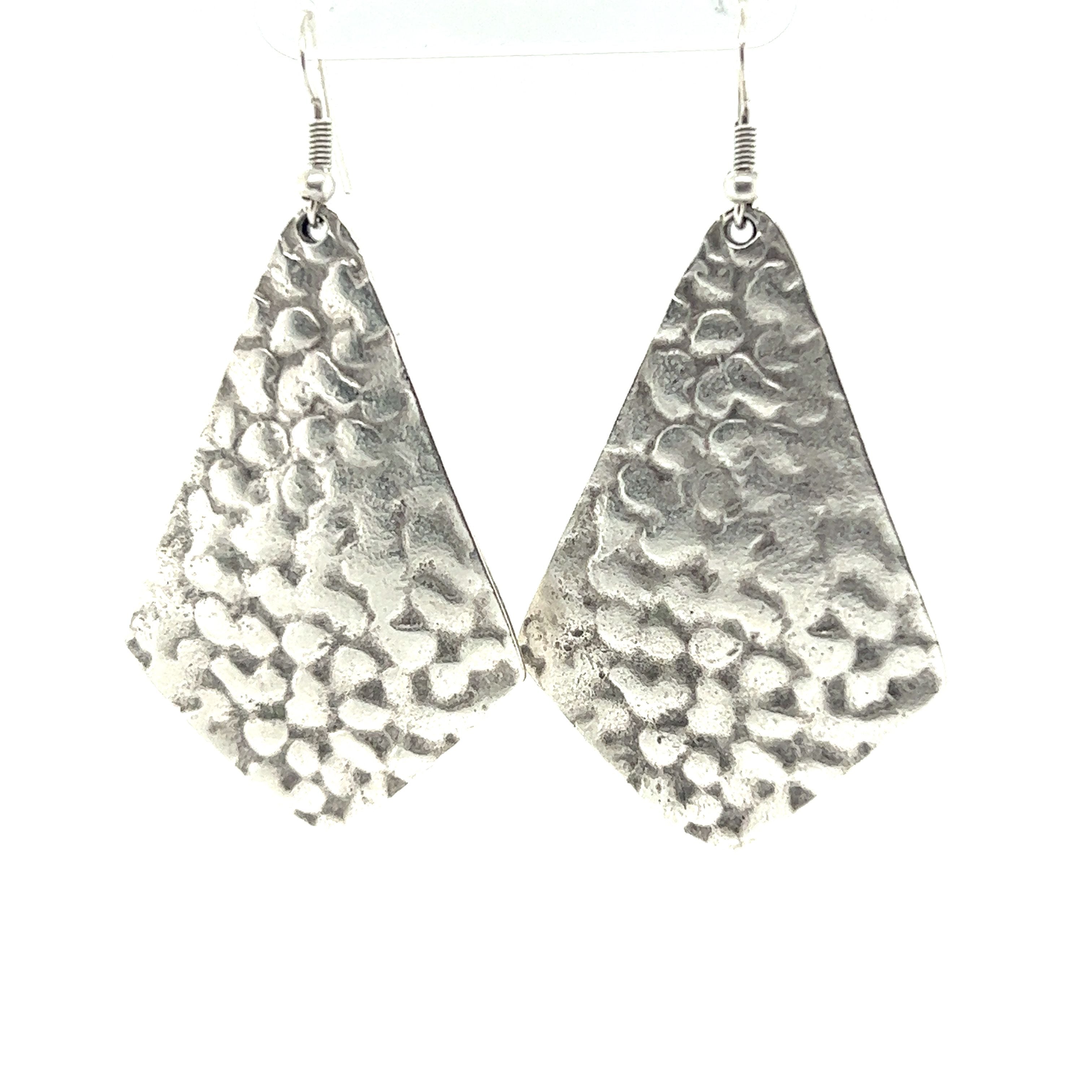 A pair of Super Silver Long Boho Statement earrings.