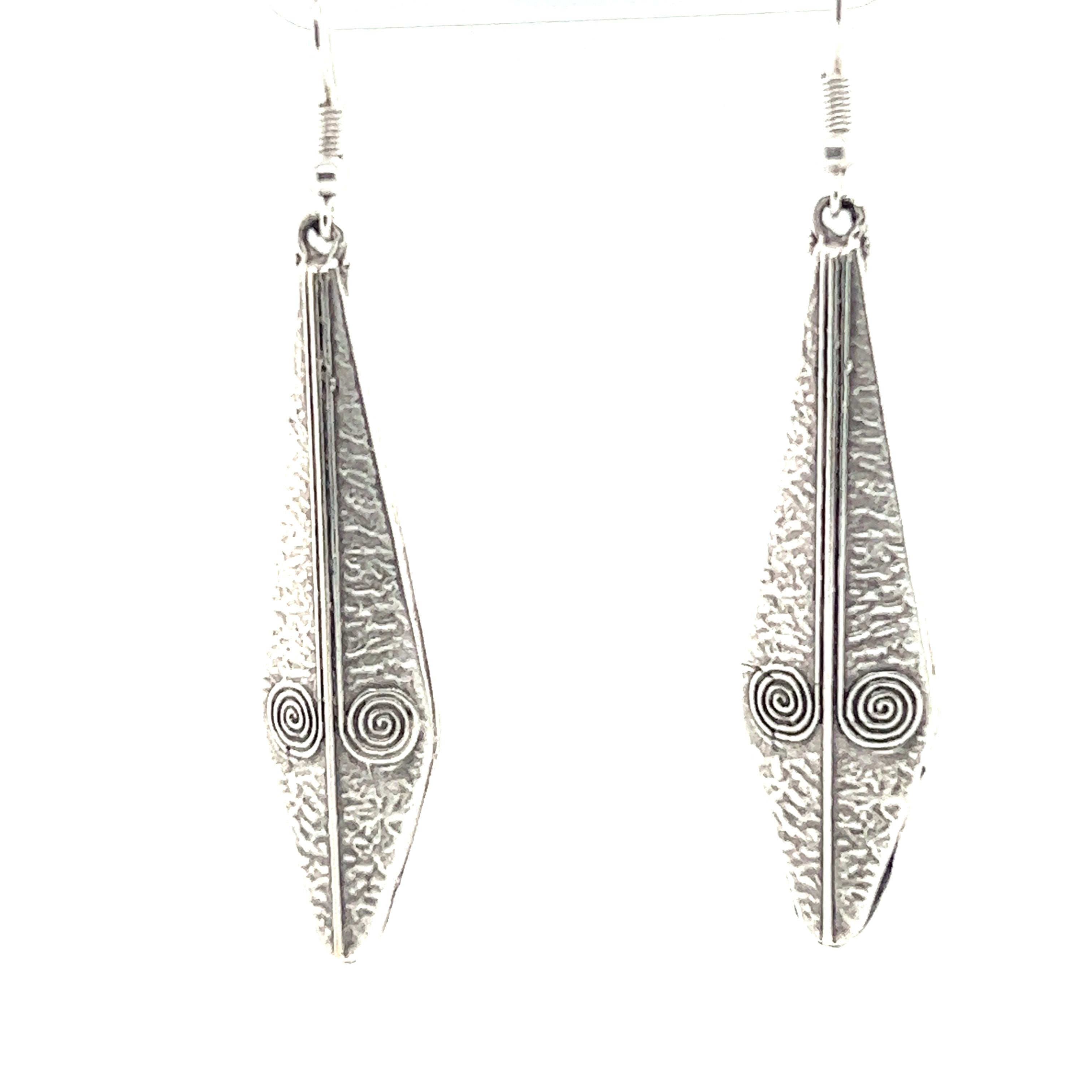 A pair of Super Silver Triangular Boho Statement Earrings with intricate designs, perfect for the urban boho jewelry trend.