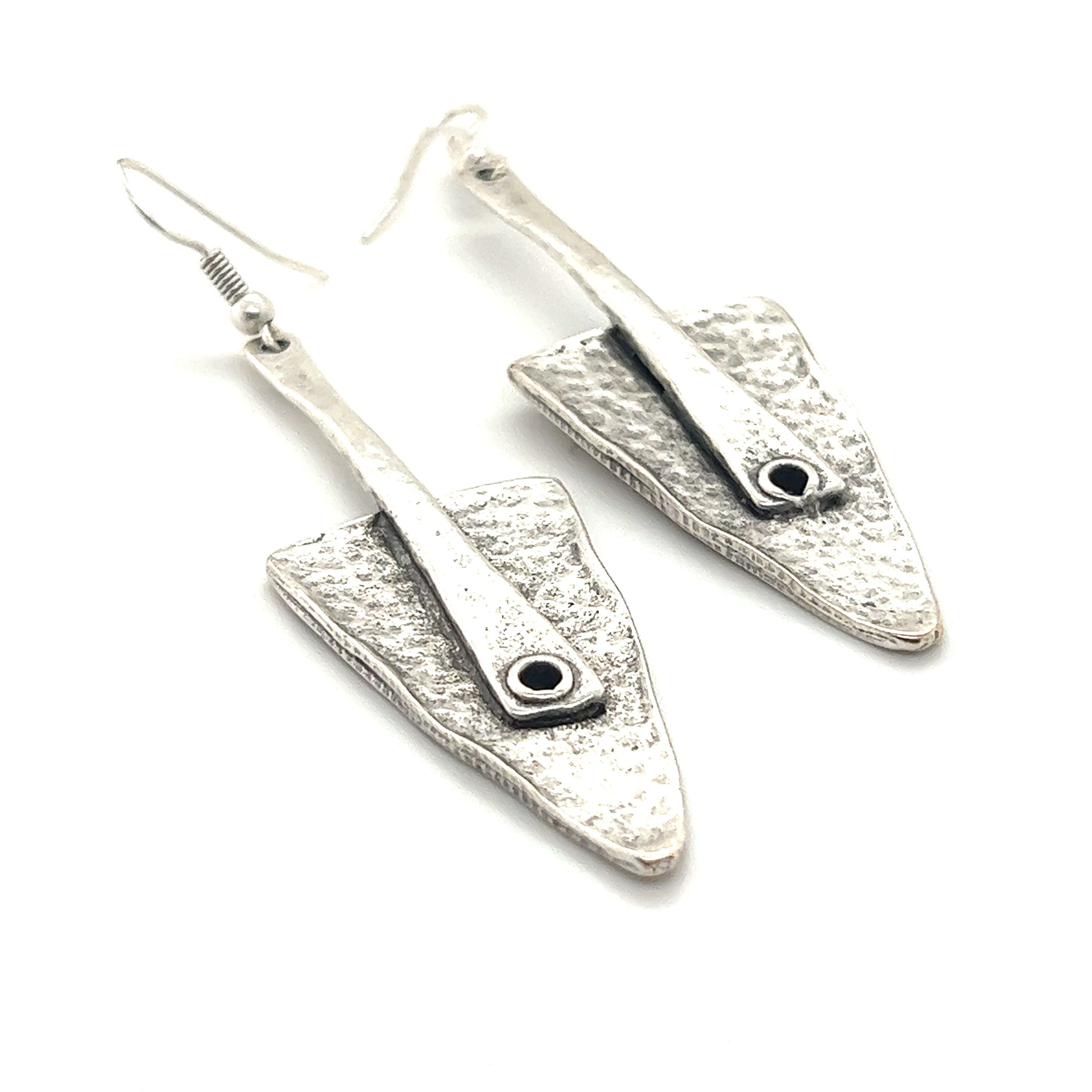 A pair of Super Silver Triangular Boho Statement Earrings with a silver and black Zamak stone in the middle.