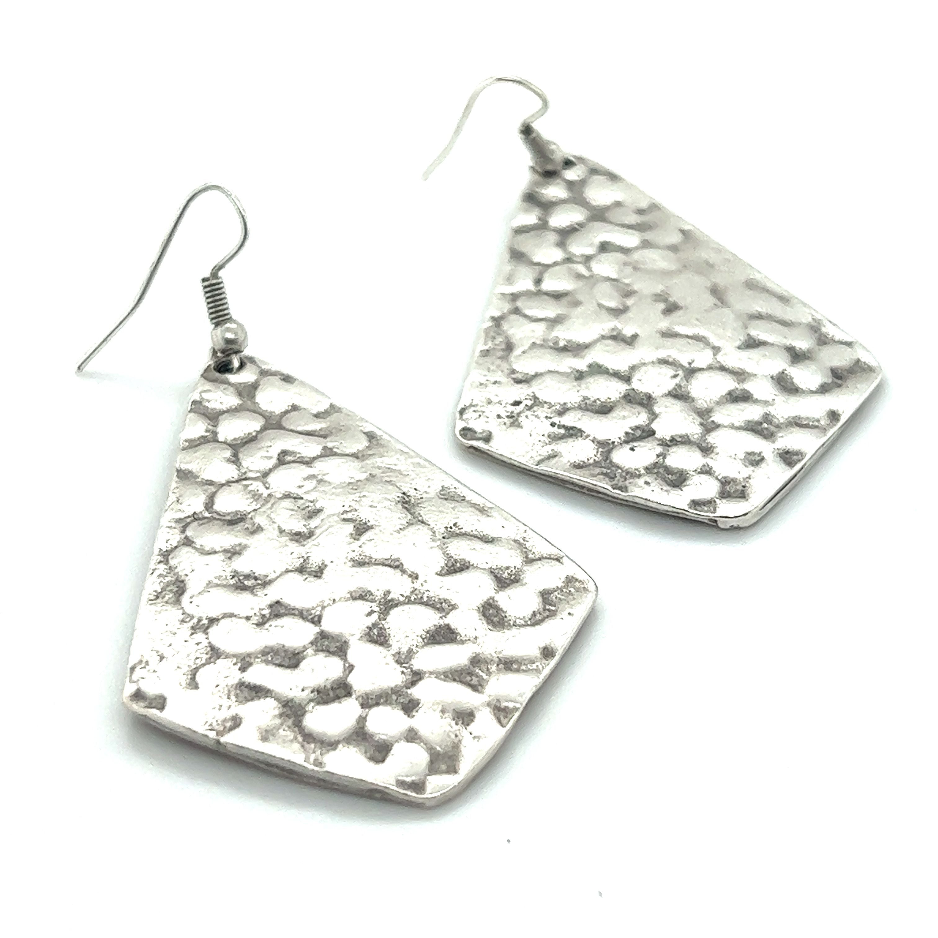 A pair of Super Silver Long Boho Statement Earrings.