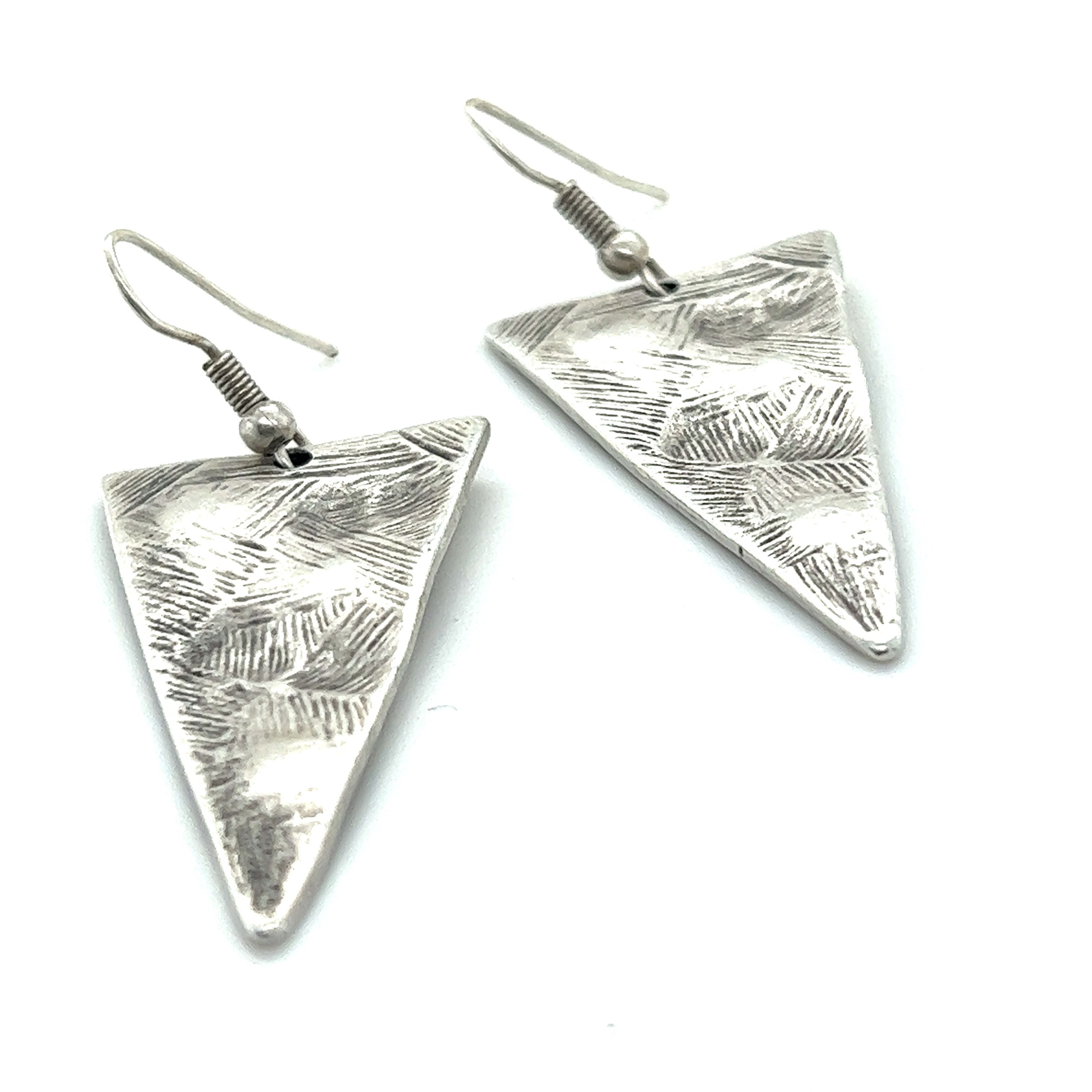 A pair of Super Silver Triangular Boho Statement Earrings on a white background.