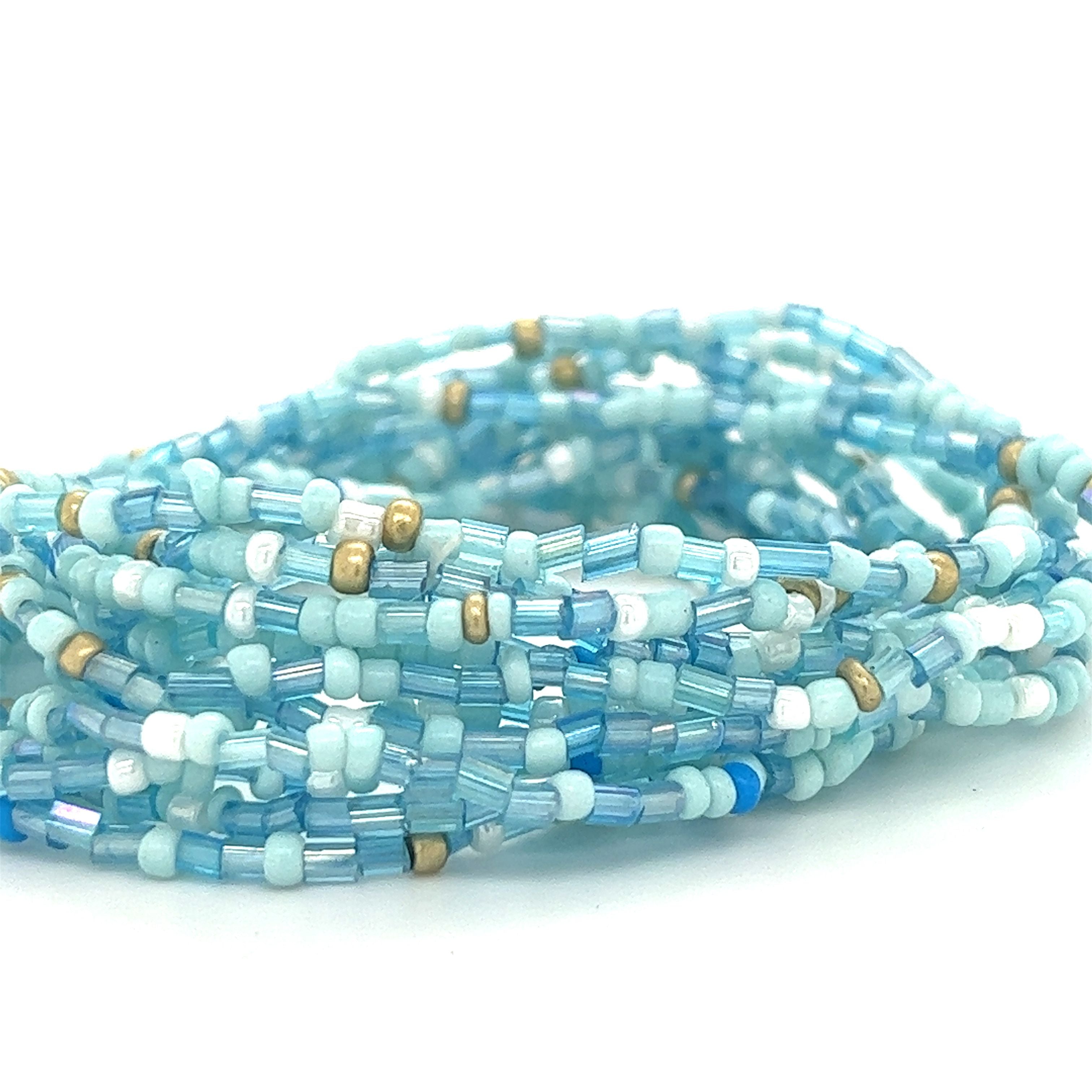 A stack of Super Silver Dainty Beaded Bracelets.