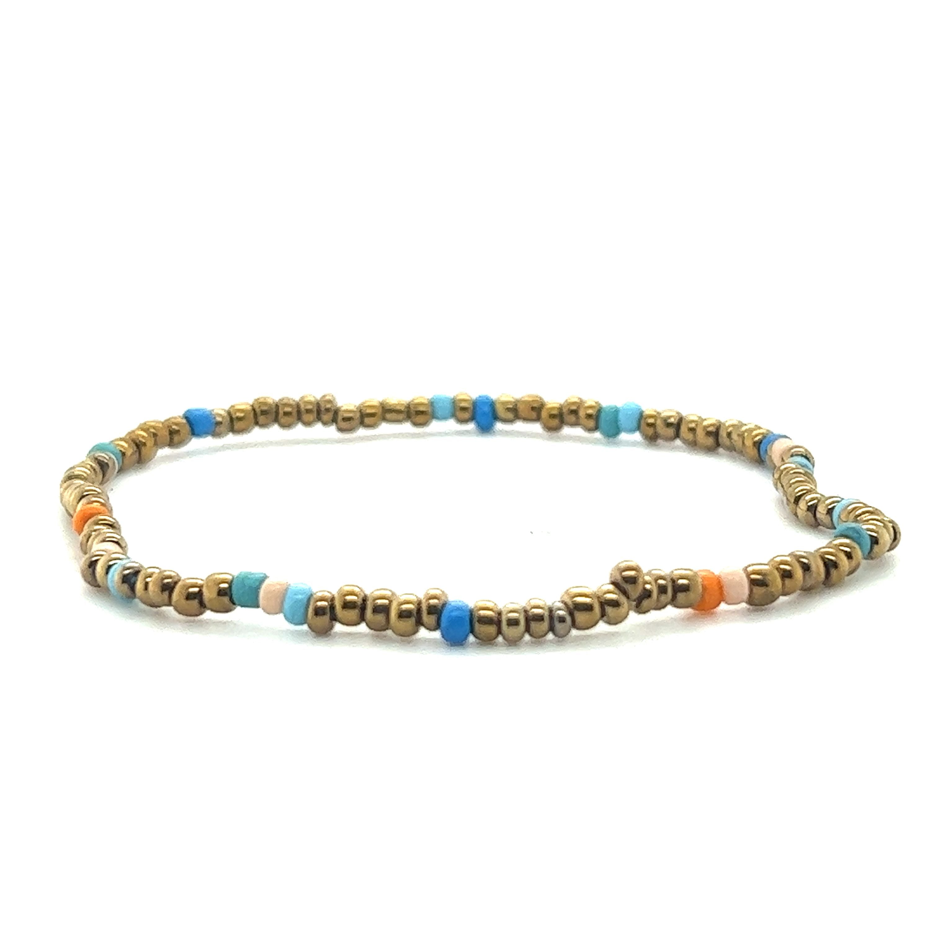 A Super Silver gold and blue Dainty Beaded Bracelet on a white background.