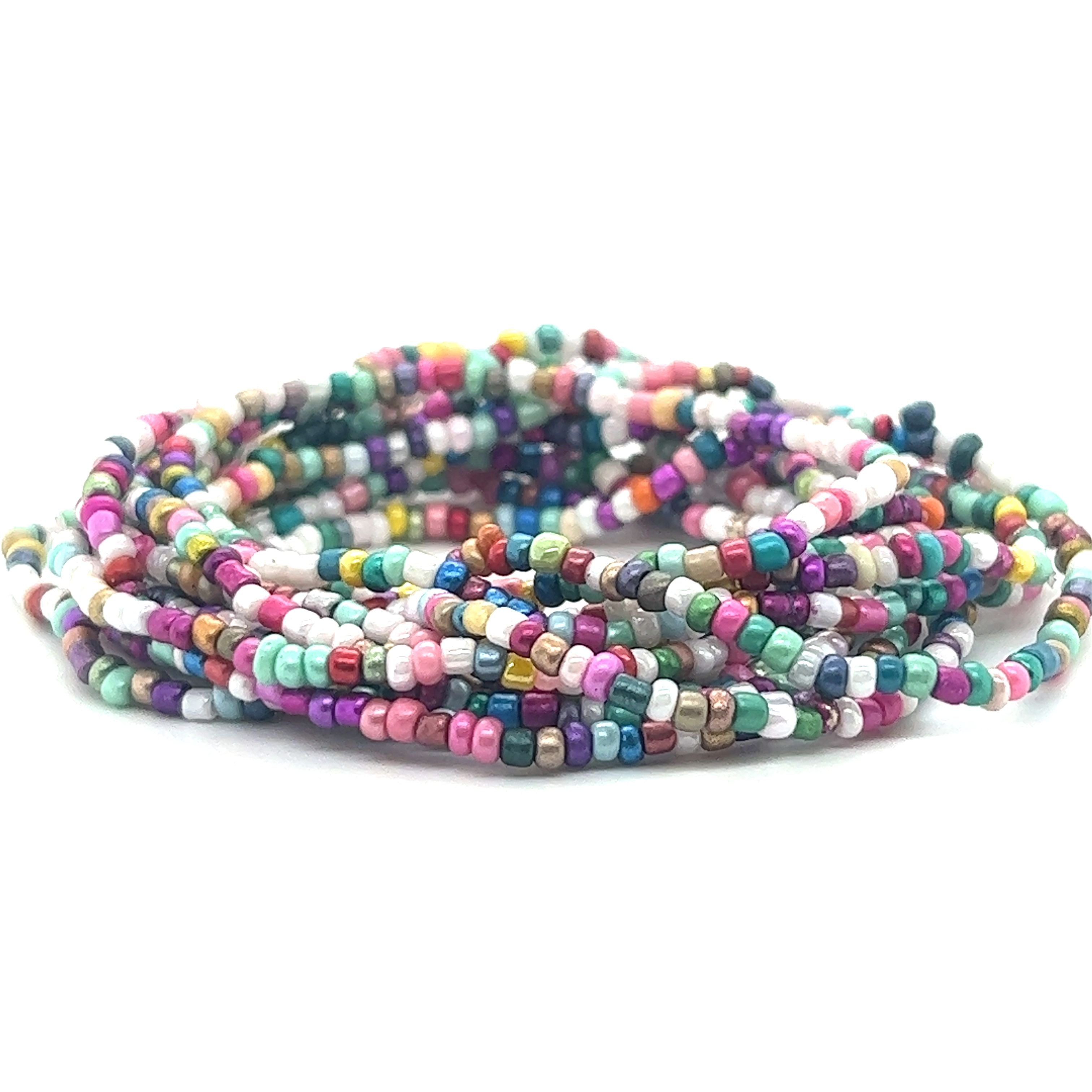 A stack of Super Silver Dainty Beaded Bracelets on a white background, perfect for making bracelets.