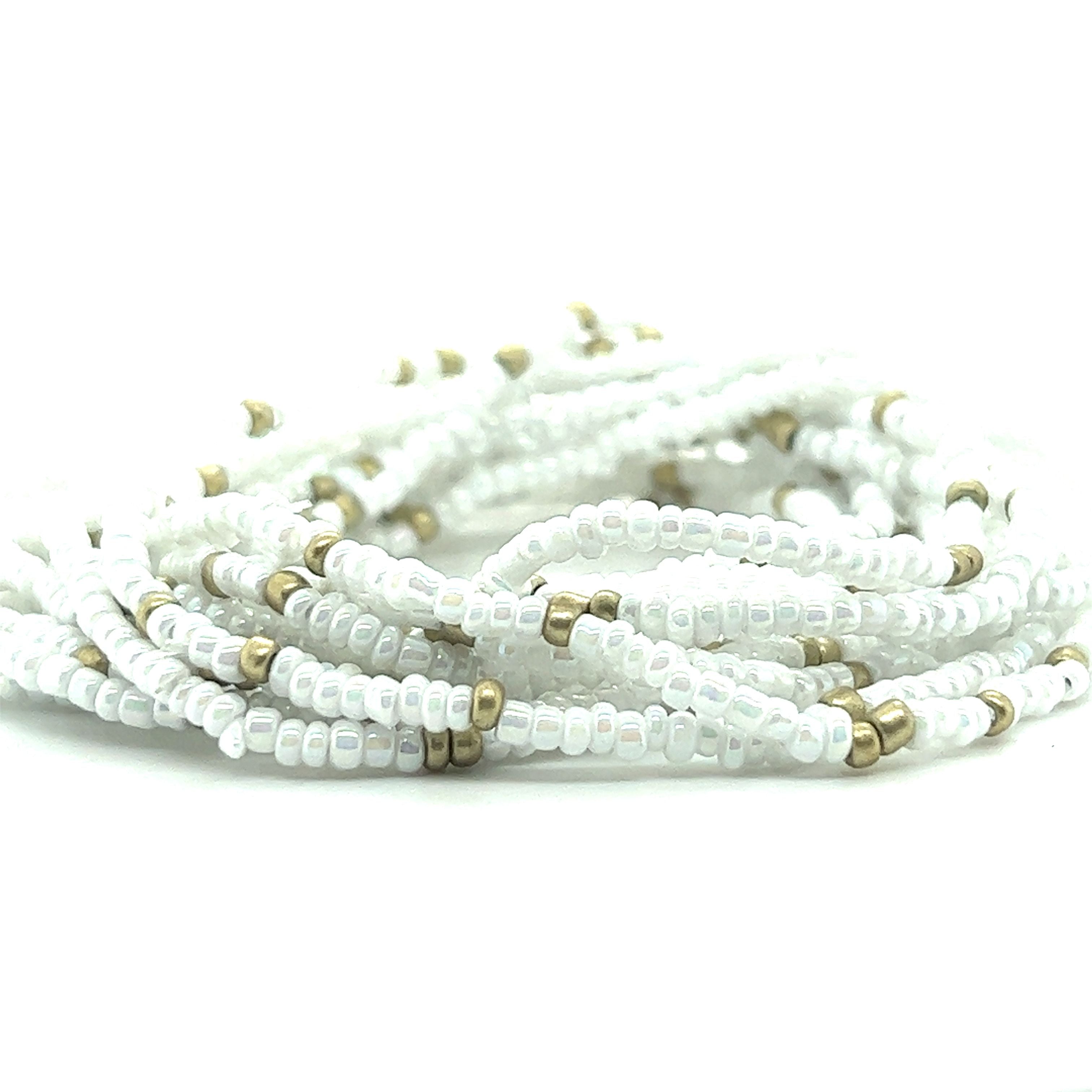 A stack of Super Silver's Dainty Beaded Bracelets in various colors on a white background.