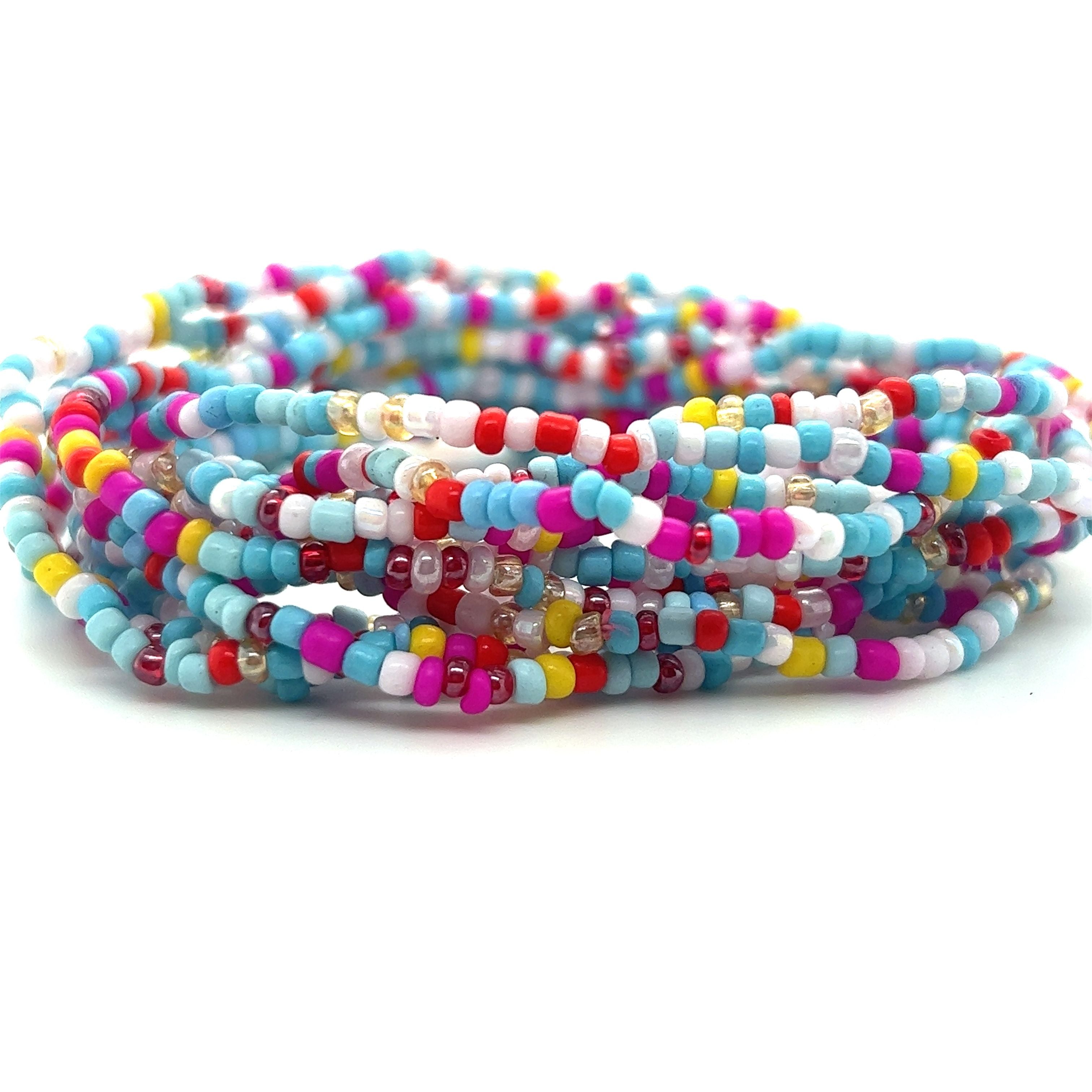 A stack of Super Silver's Dainty Beaded Bracelets on a white background.