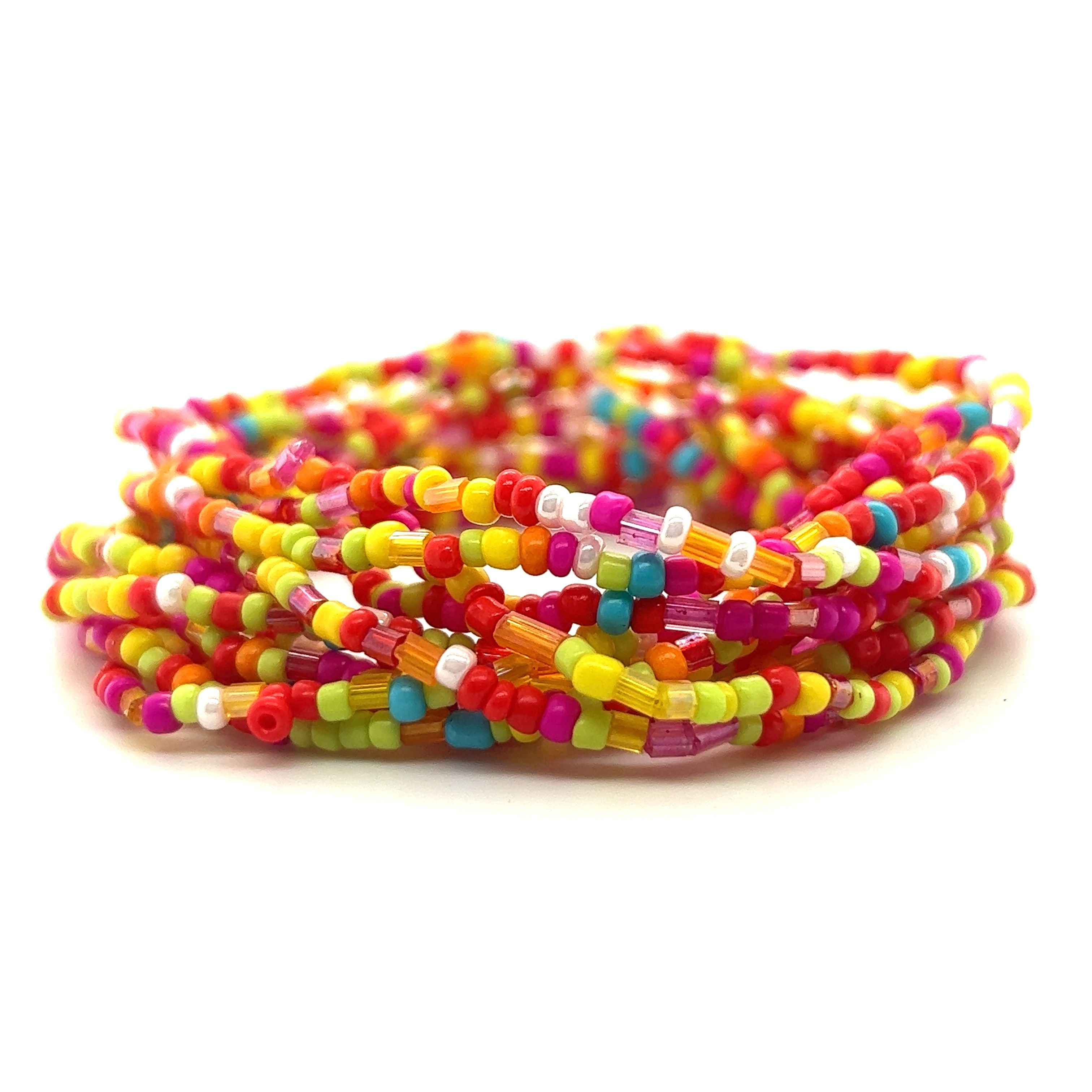 A stack of vibrant Dainty Beaded Bracelets made with seed beads, showcasing a kaleidoscope of colors, all set against a pristine white background by Super Silver.