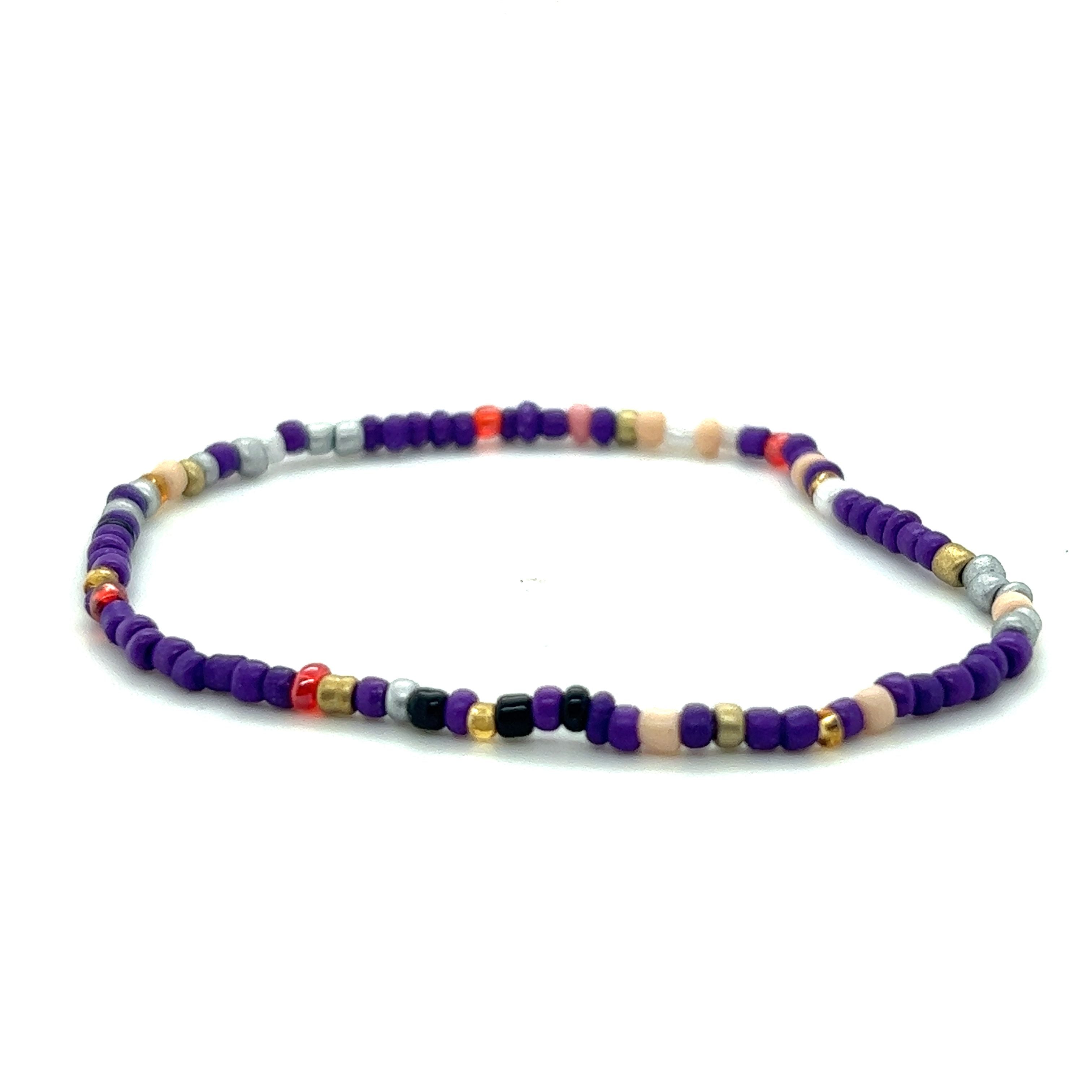 A purple and multi colored Dainty Beaded Bracelet on a white background, by Super Silver.