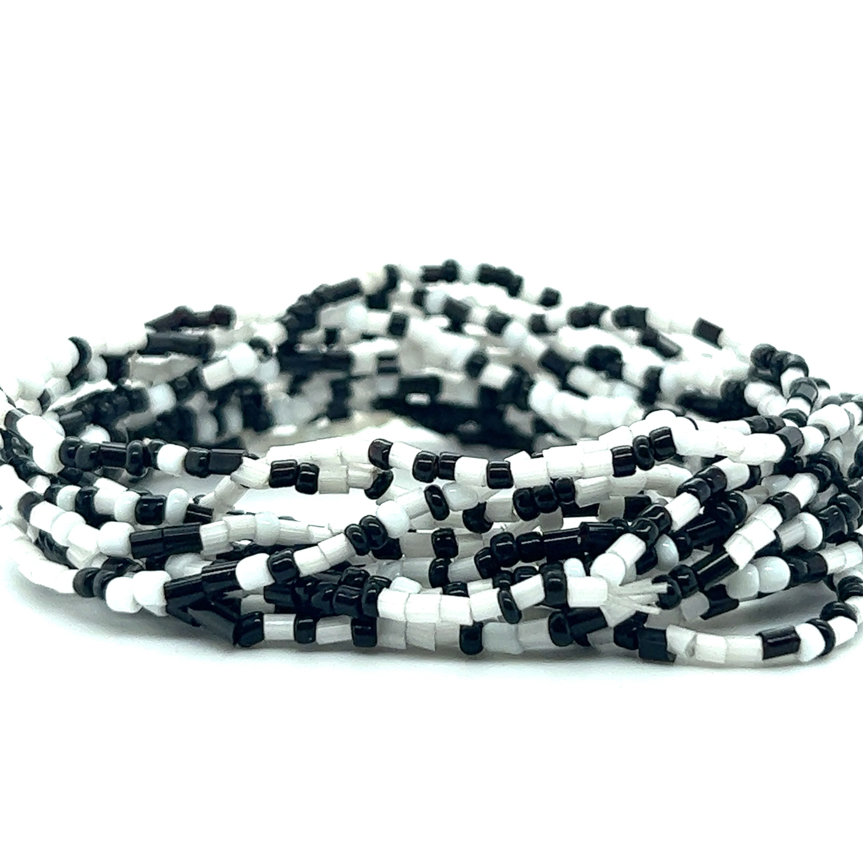 A stack of Dainty Beaded Bracelets from Super Silver on a white surface, perfect for creating stylish bracelets.