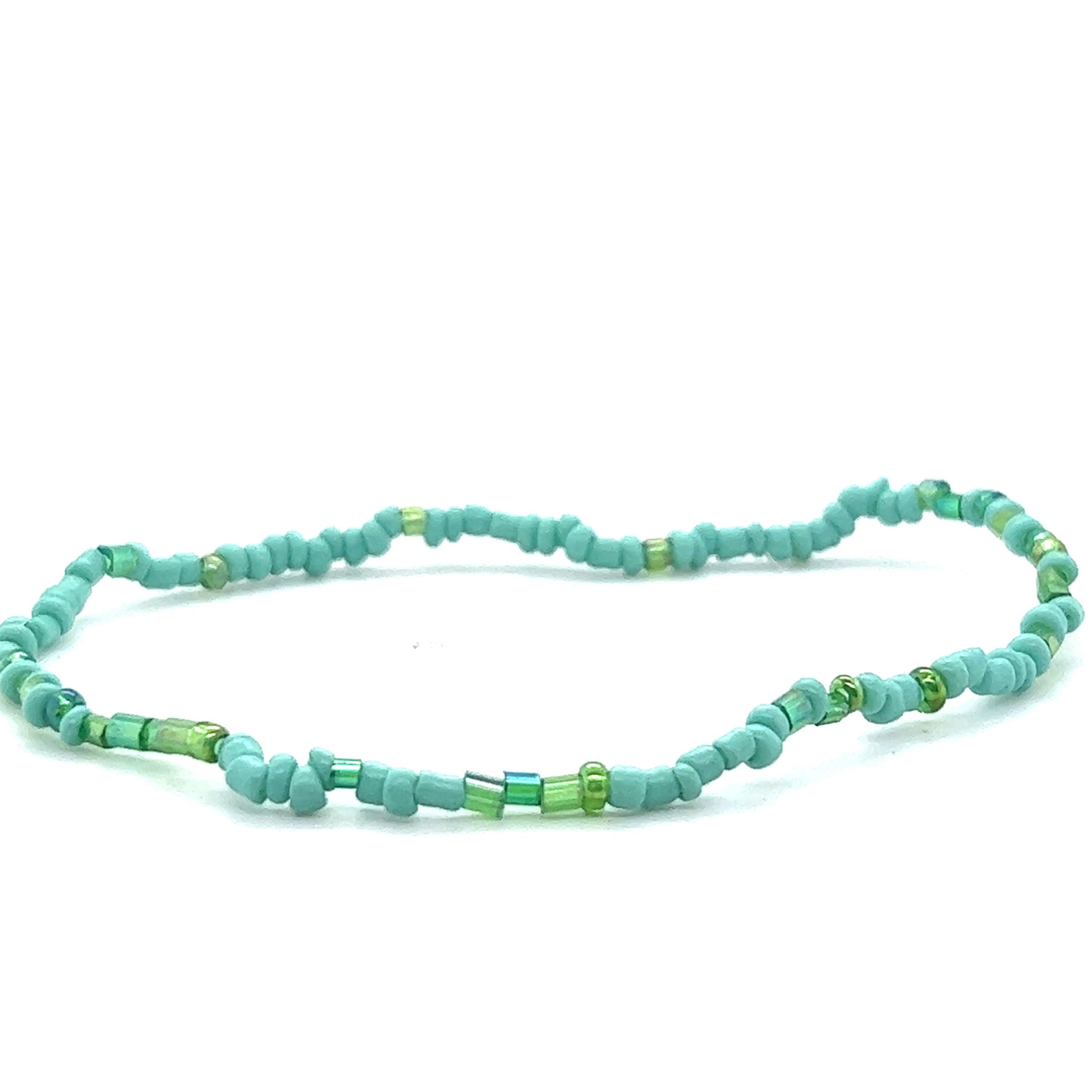 A Dainty Beaded Bracelet in turquoise and green colors on a white background by Super Silver.