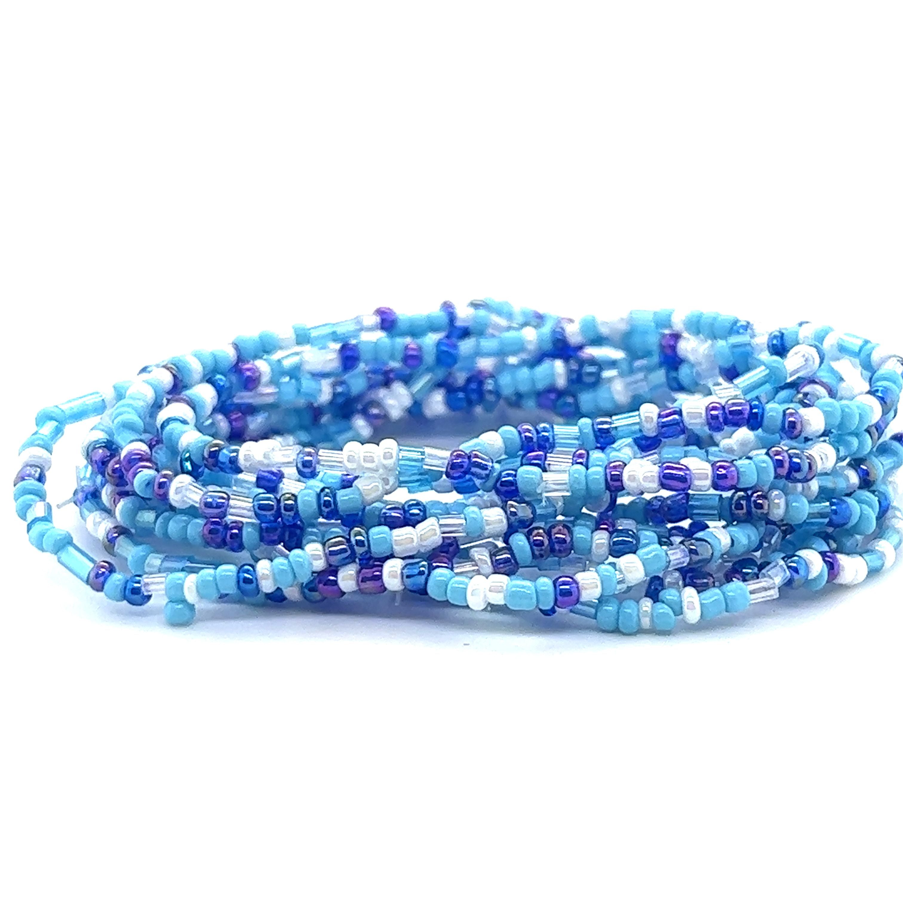 A stack of blue and white Dainty Beaded Bracelets by Super Silver on a white bracelet background.