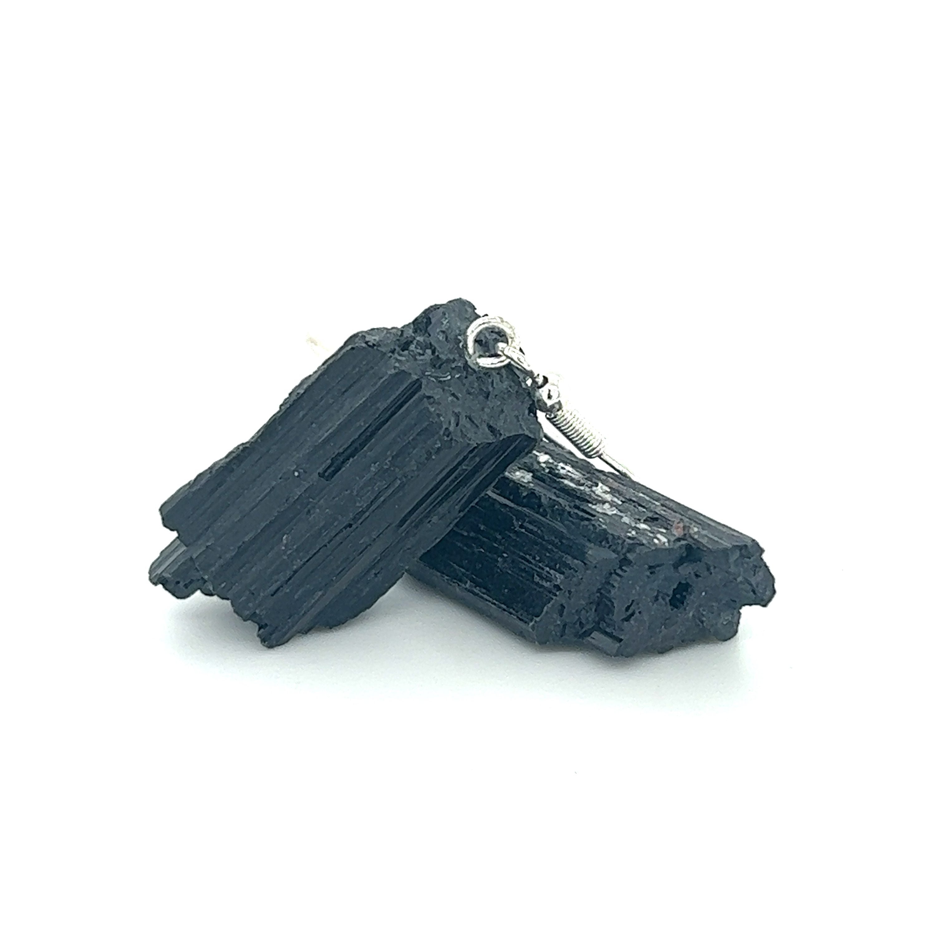 A pair of Super Silver Raw Crystal Earrings, made of black tourmaline and amethyst crystals, on a white background.