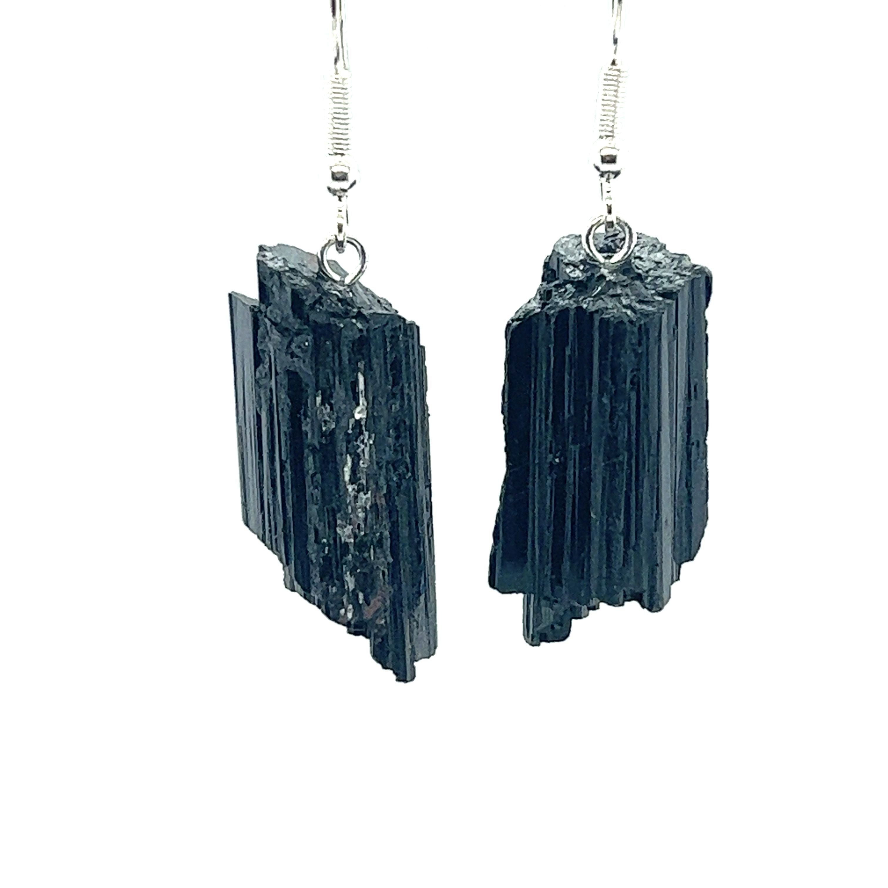 A pair of Super Silver Raw Crystal Earrings featuring black tourmaline on a white background.