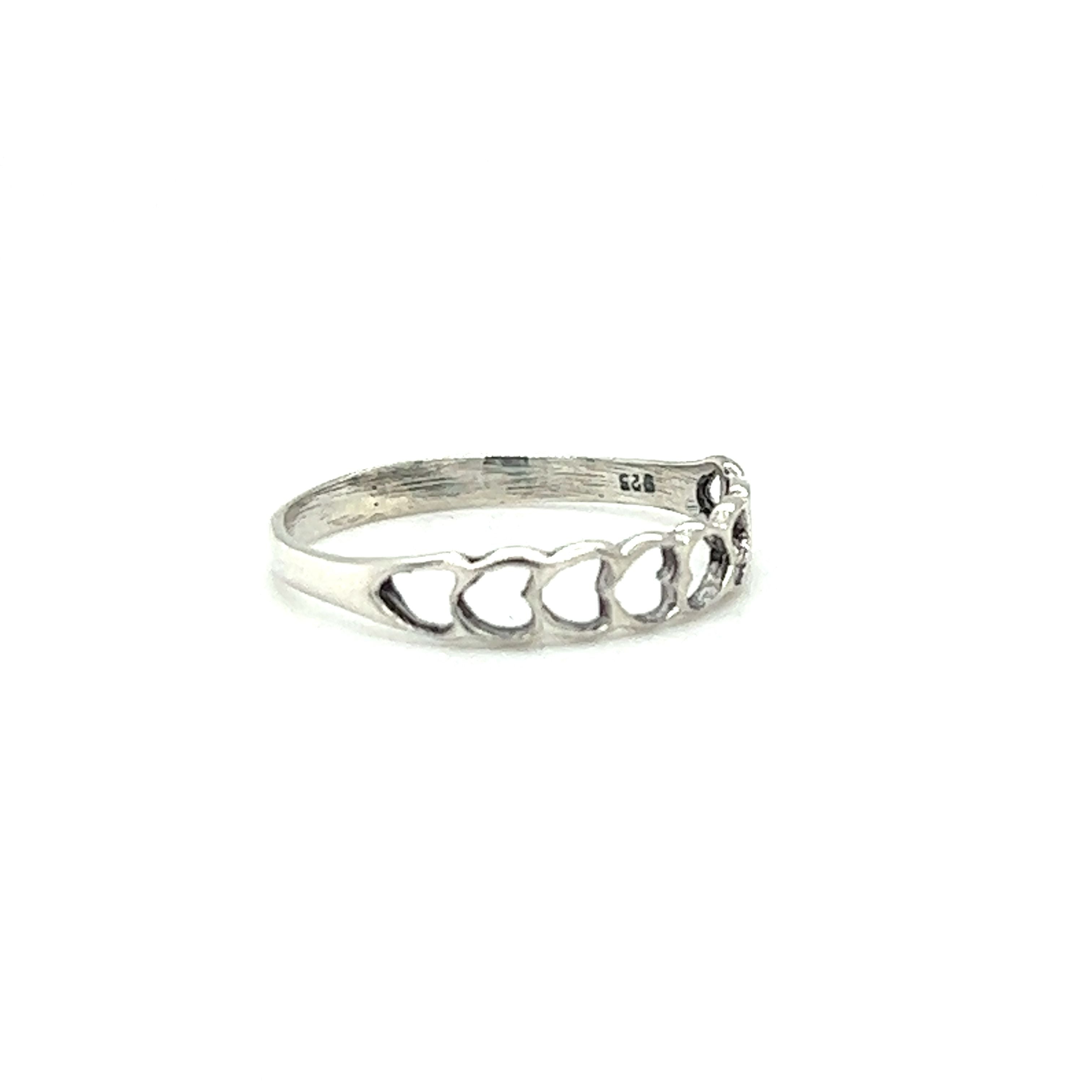 A minimalist Delicate Heart Cutout Band with hearts on it.