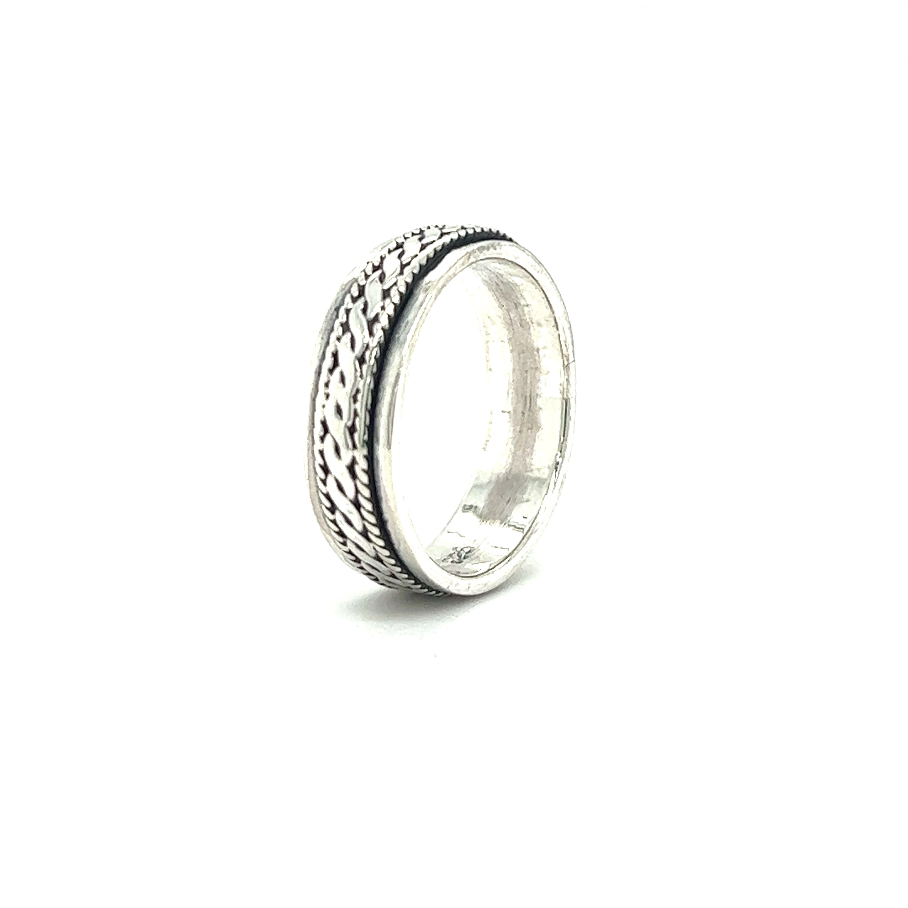 A Spinner Ring With Rope Design with a pattern weave.