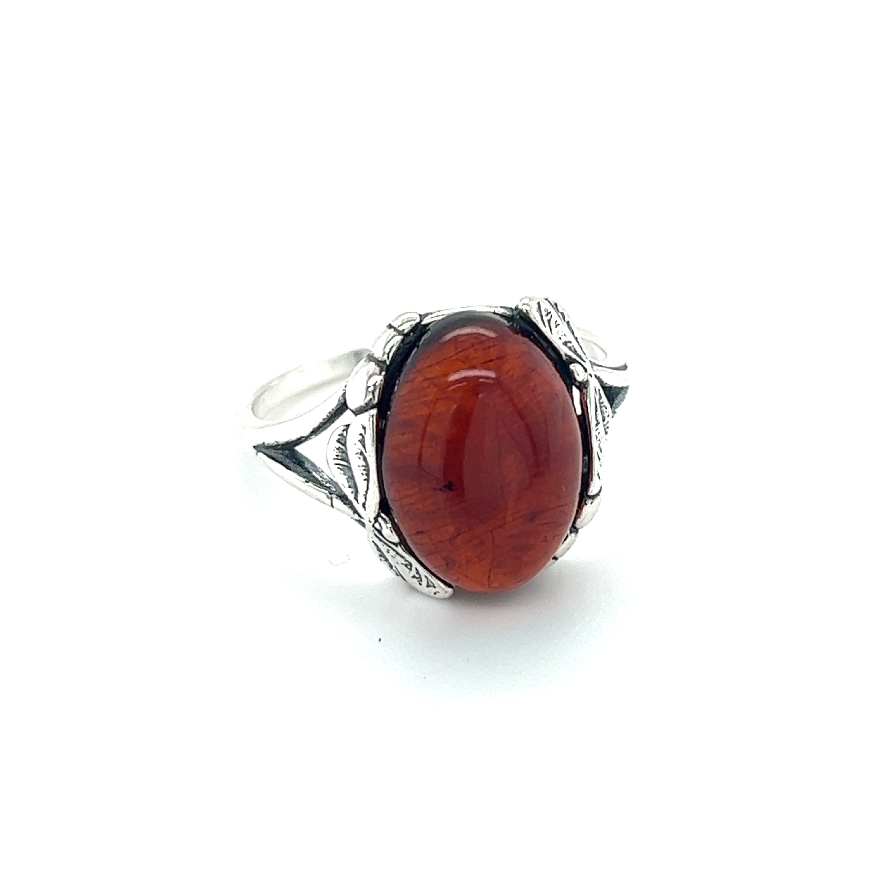 A Dragonfly Band Amber Ring by Super Silver with an orange stone.