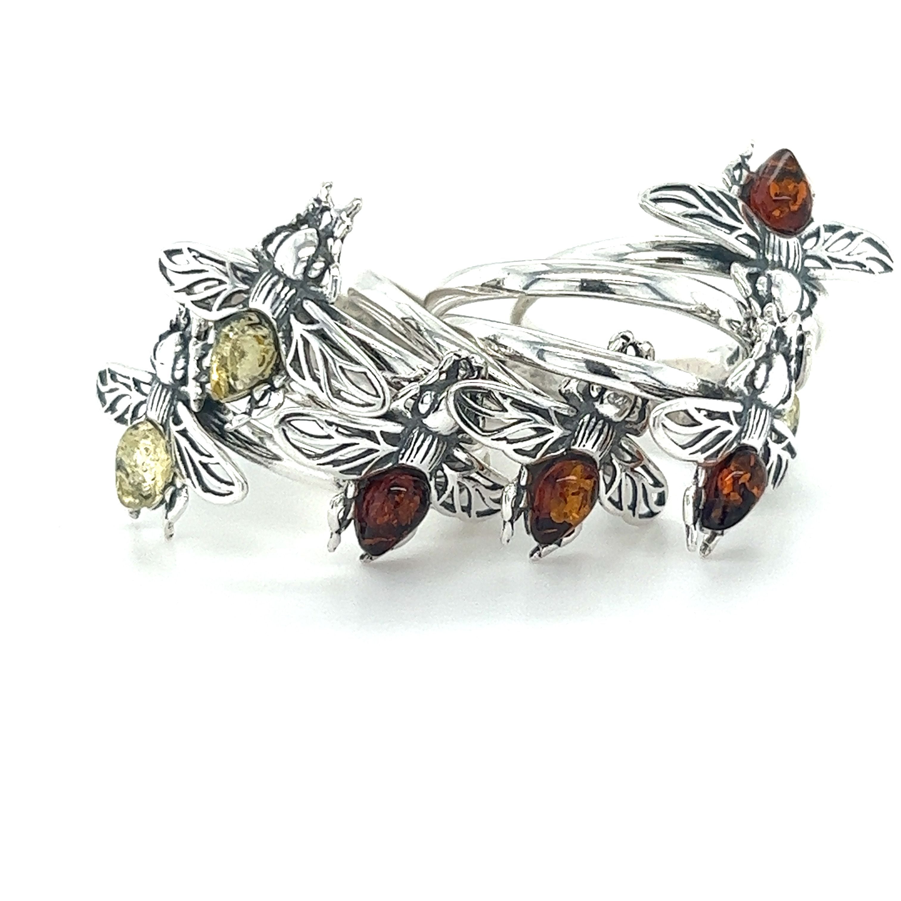 A Detailed Baltic Amber Bee Ring adorned with amber stones made by Super Silver.