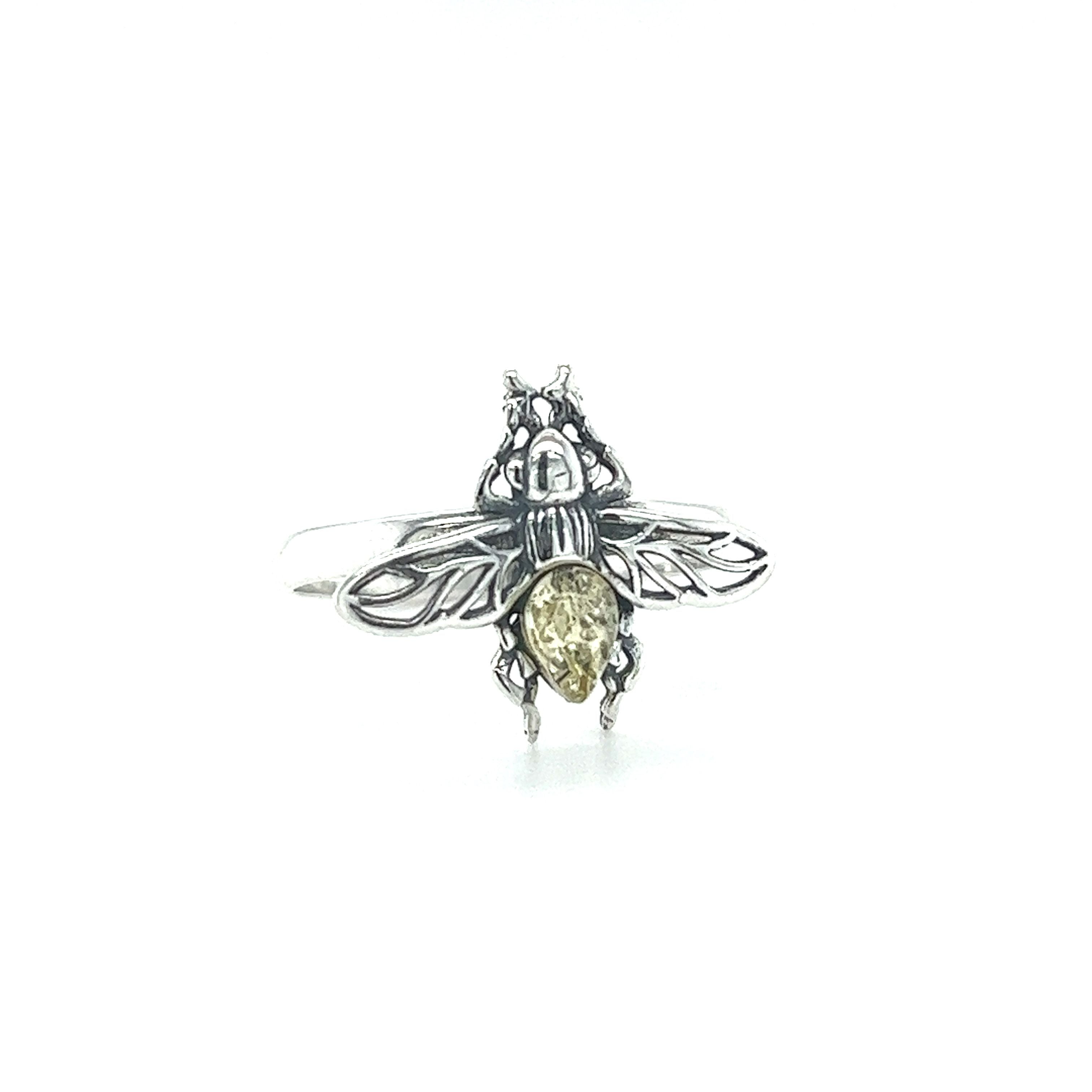 A Detailed Baltic Amber Bee Ring by Super Silver with a silver bee on it.