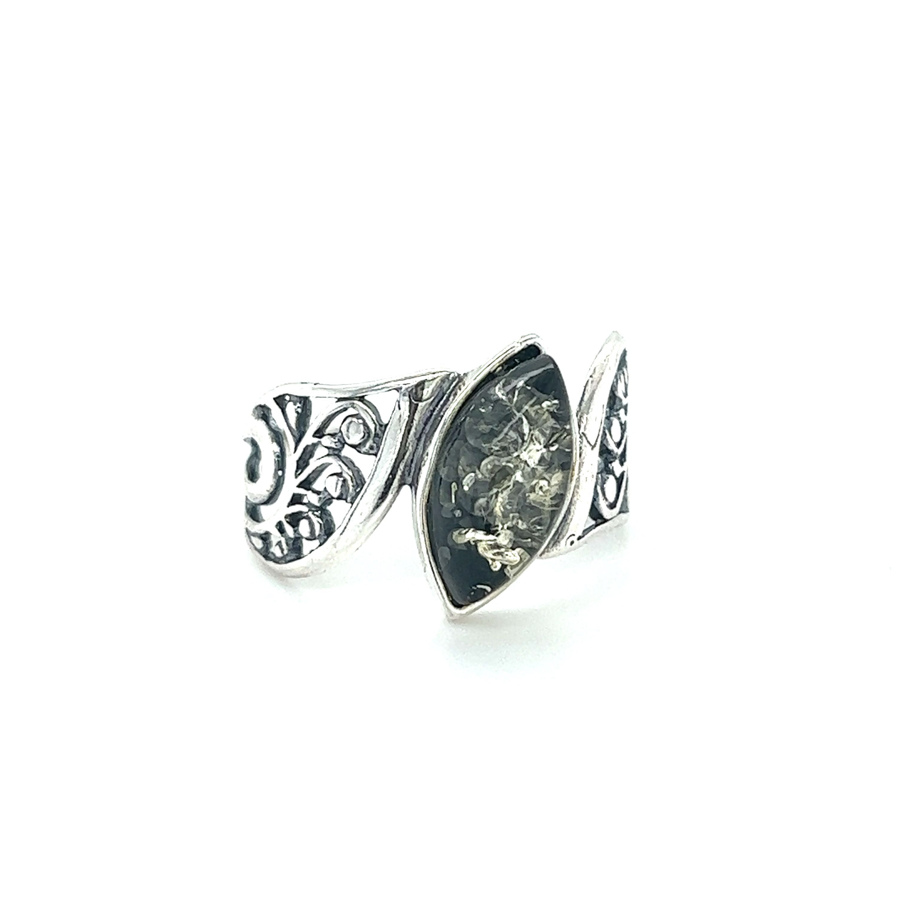 A Wide Filigree Band Baltic Amber Ring from Super Silver with an ornate design on it.
