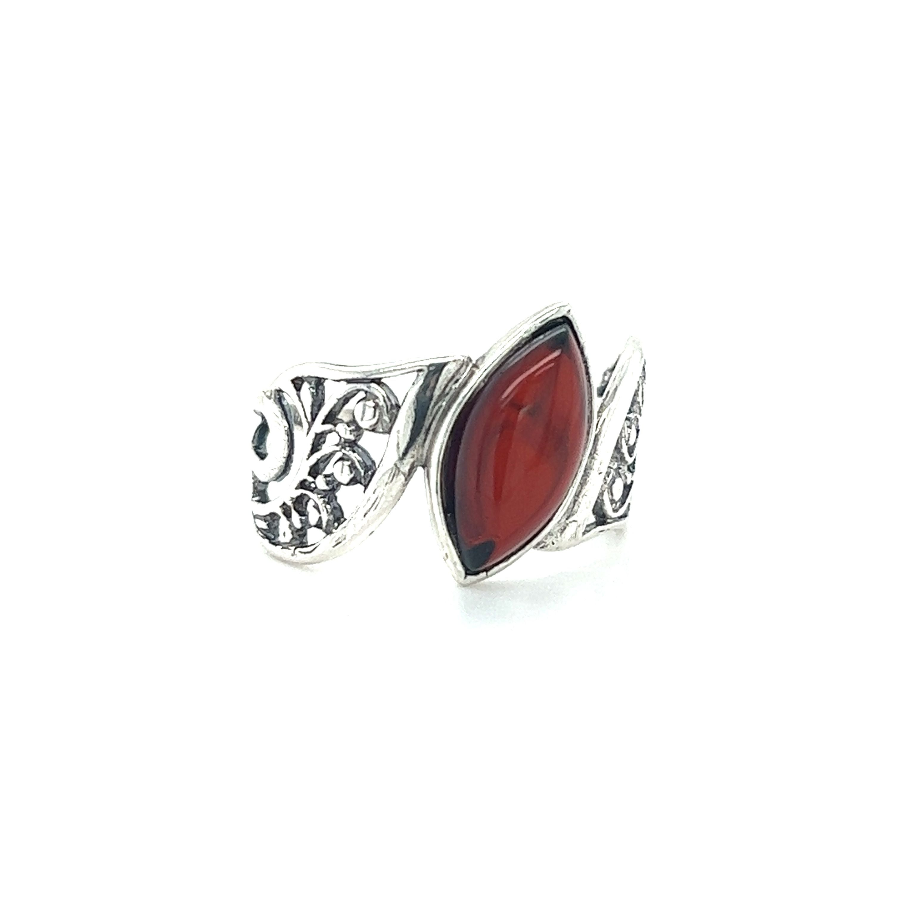 A Wide Filigree Band Baltic Amber Ring with a red stone from Super Silver.