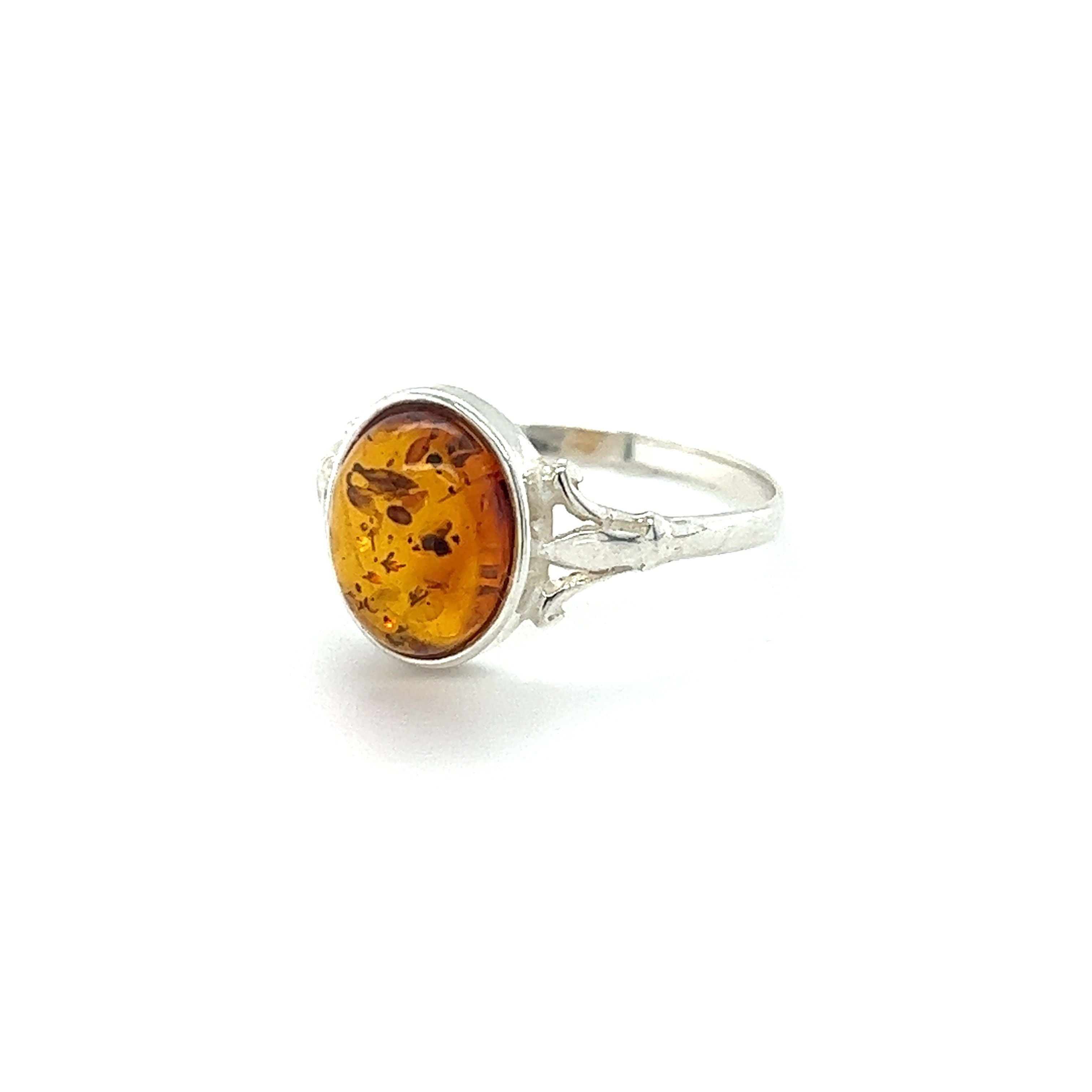 A Super Silver Glowing Oval Amber Ring featuring Baltic amber, displayed on a white background.