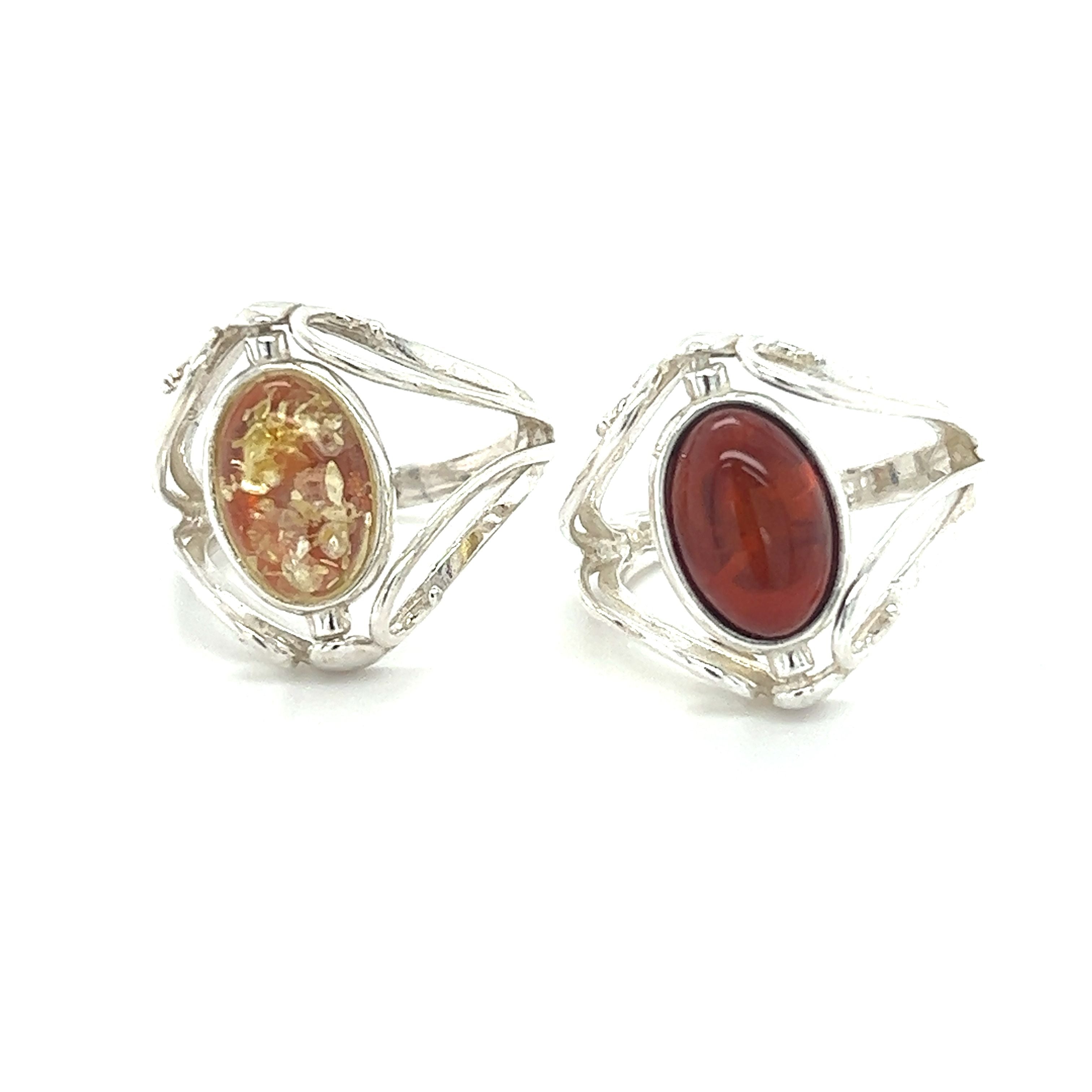 A pair of Super Silver Rotating Lemon and Cherry Amber rings featuring Baltic amber and carnelian stones.