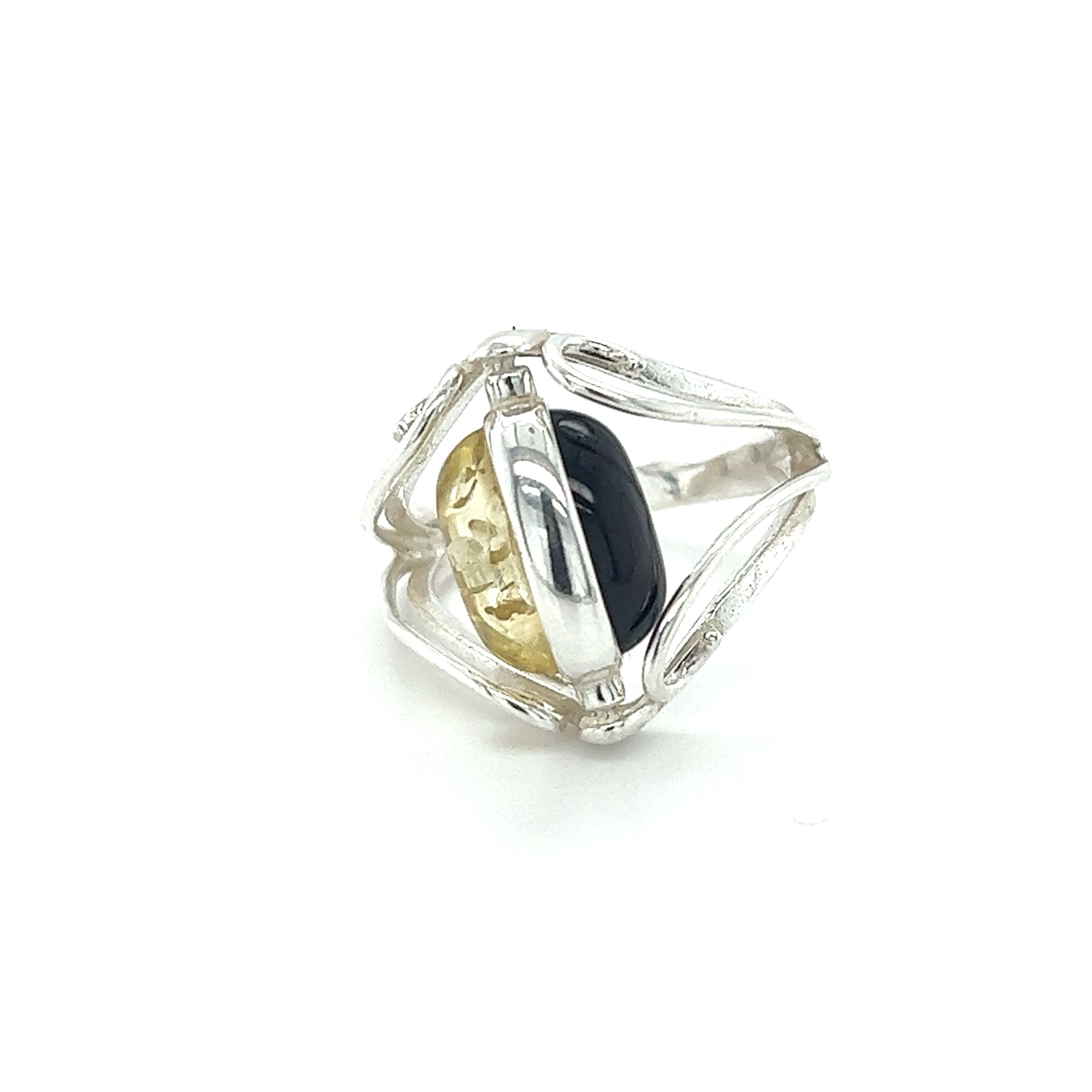 A statement Rotating Lemon and Cherry Amber Ring with a Baltic amber stone in black and yellow by Super Silver.