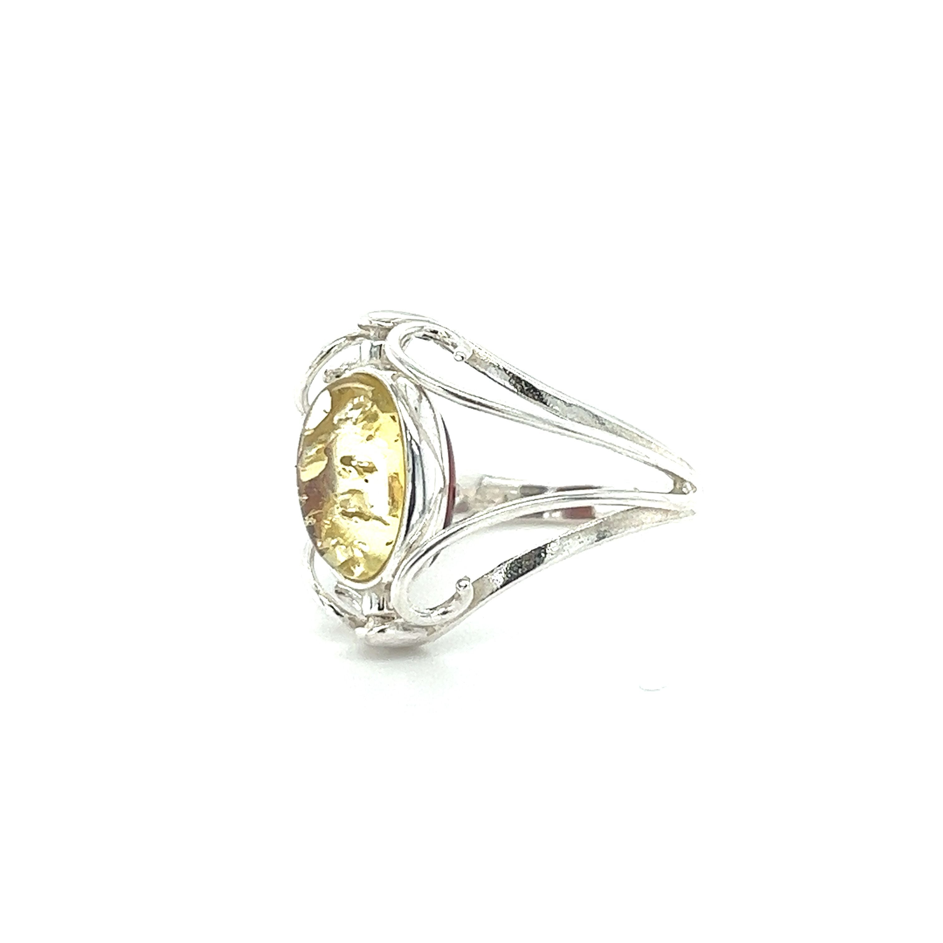 A Rotating Lemon and Cherry Amber Ring made of sterling silver and featuring a yellow citrine stone.