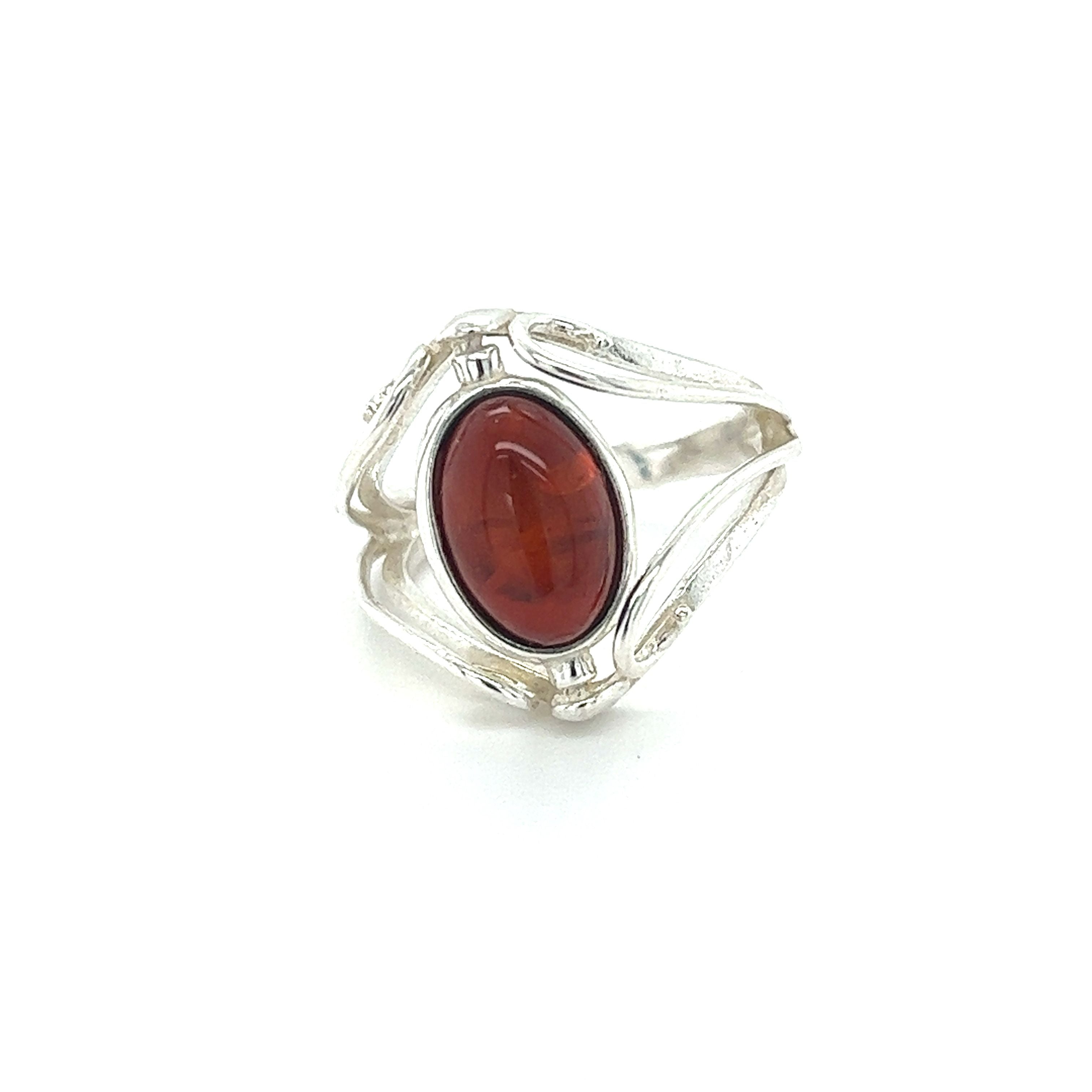 A statement ring featuring a silver band and a vibrant red stone, crafted from Rotating Lemon and Cherry Amber, by Super Silver.