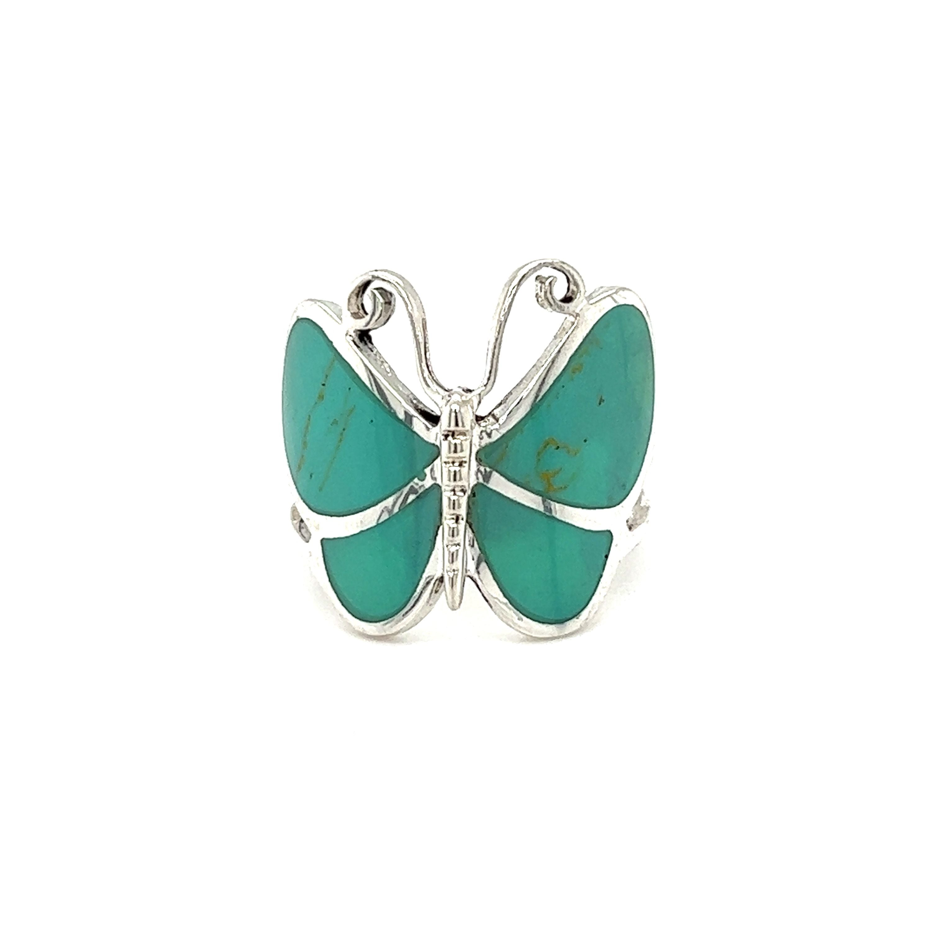 A Bold Butterfly ring with inlaid stones in turquoise.