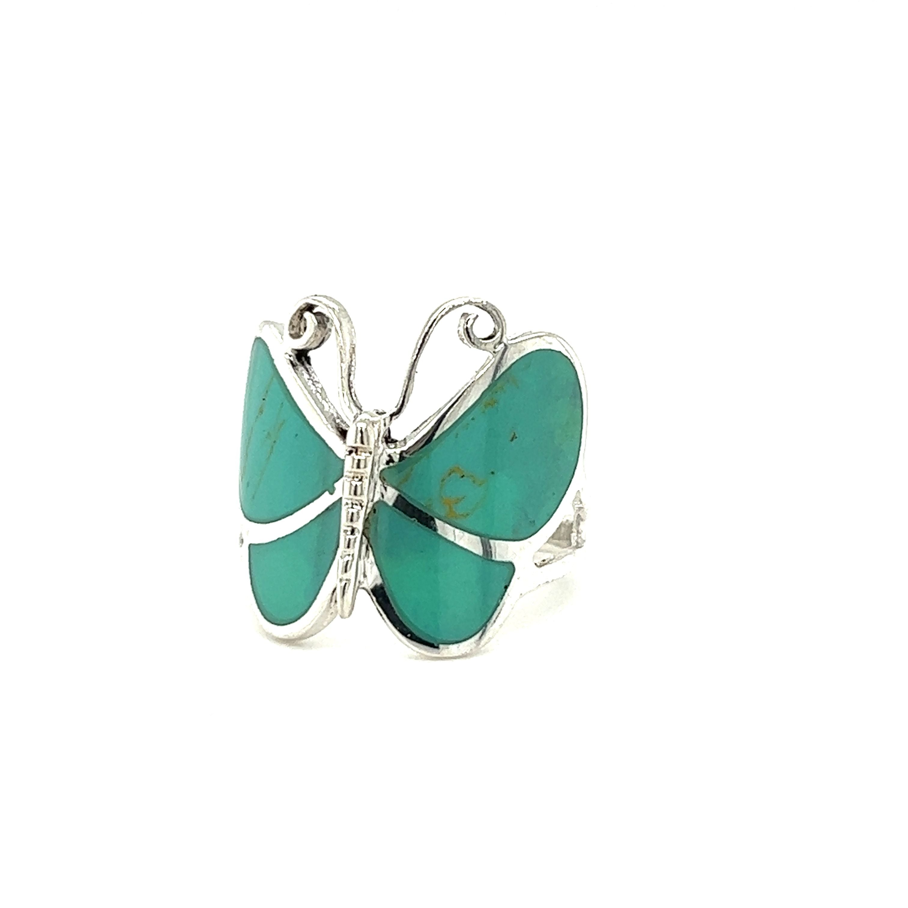 A Bold Butterfly Ring with Inlaid Stones adorned with turquoise stones.