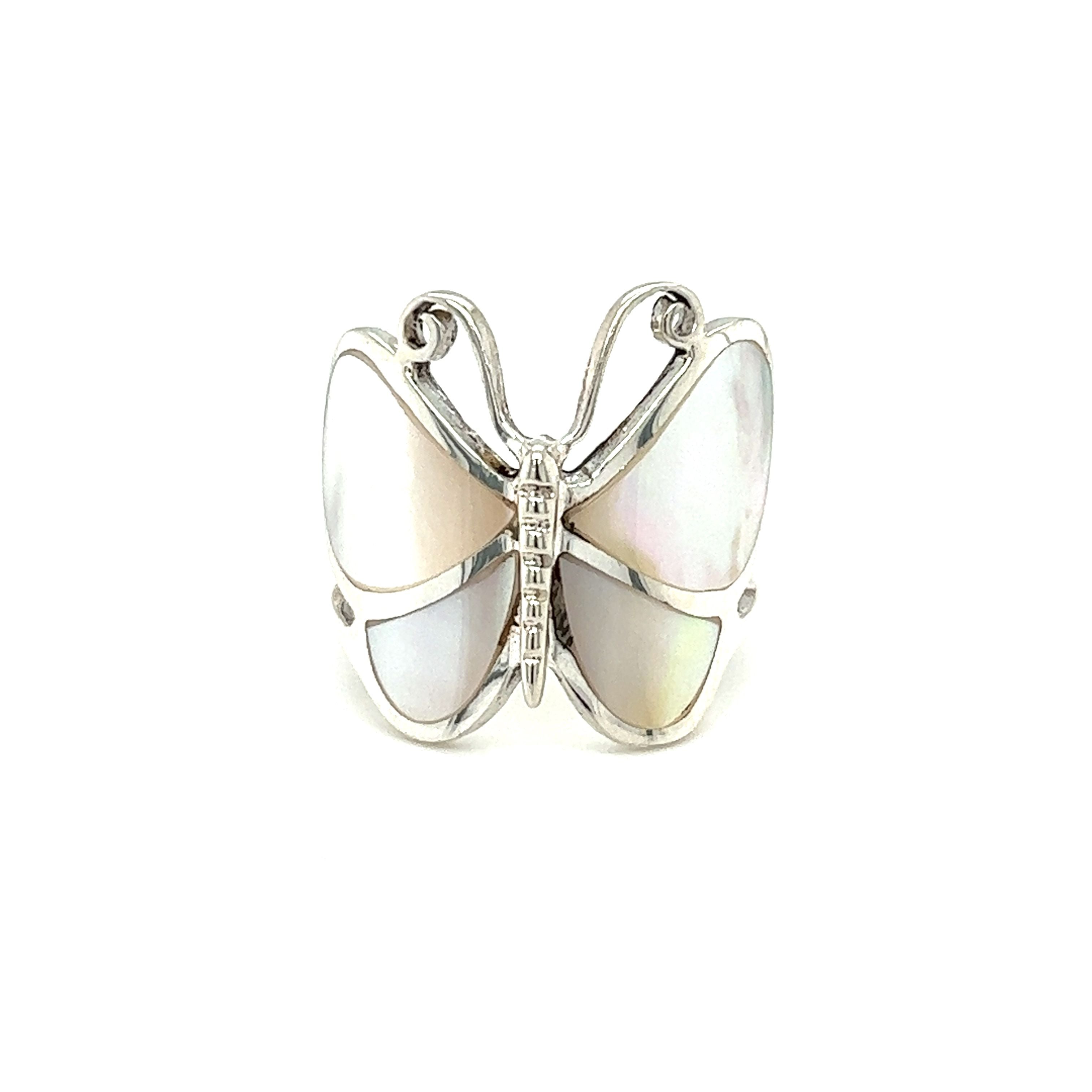A Bold Butterfly Ring with Inlaid Stones with a mother of pearl stone on a white background.