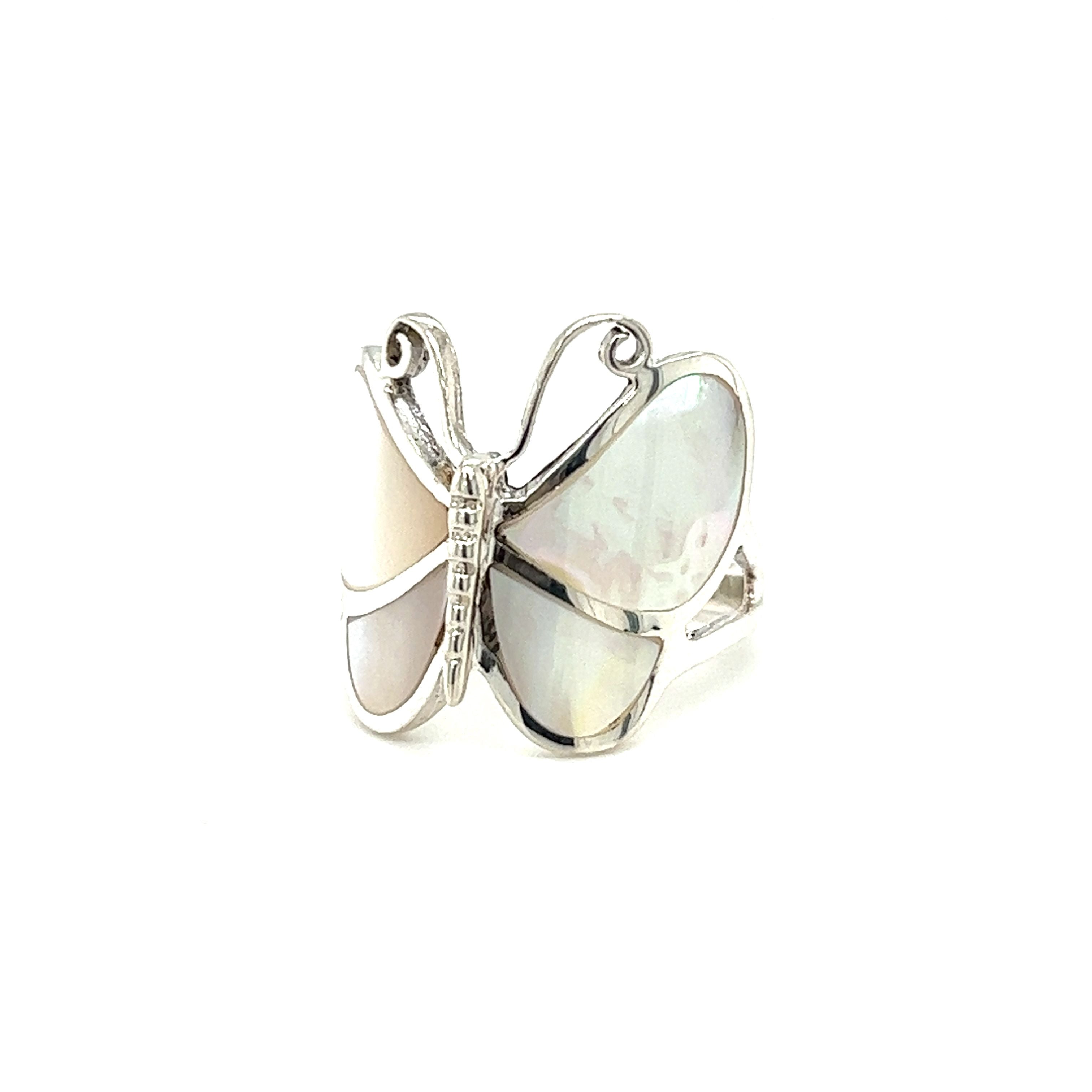 A Bold Butterfly Ring with Inlaid Stones with a mother of pearl stone on a white background.