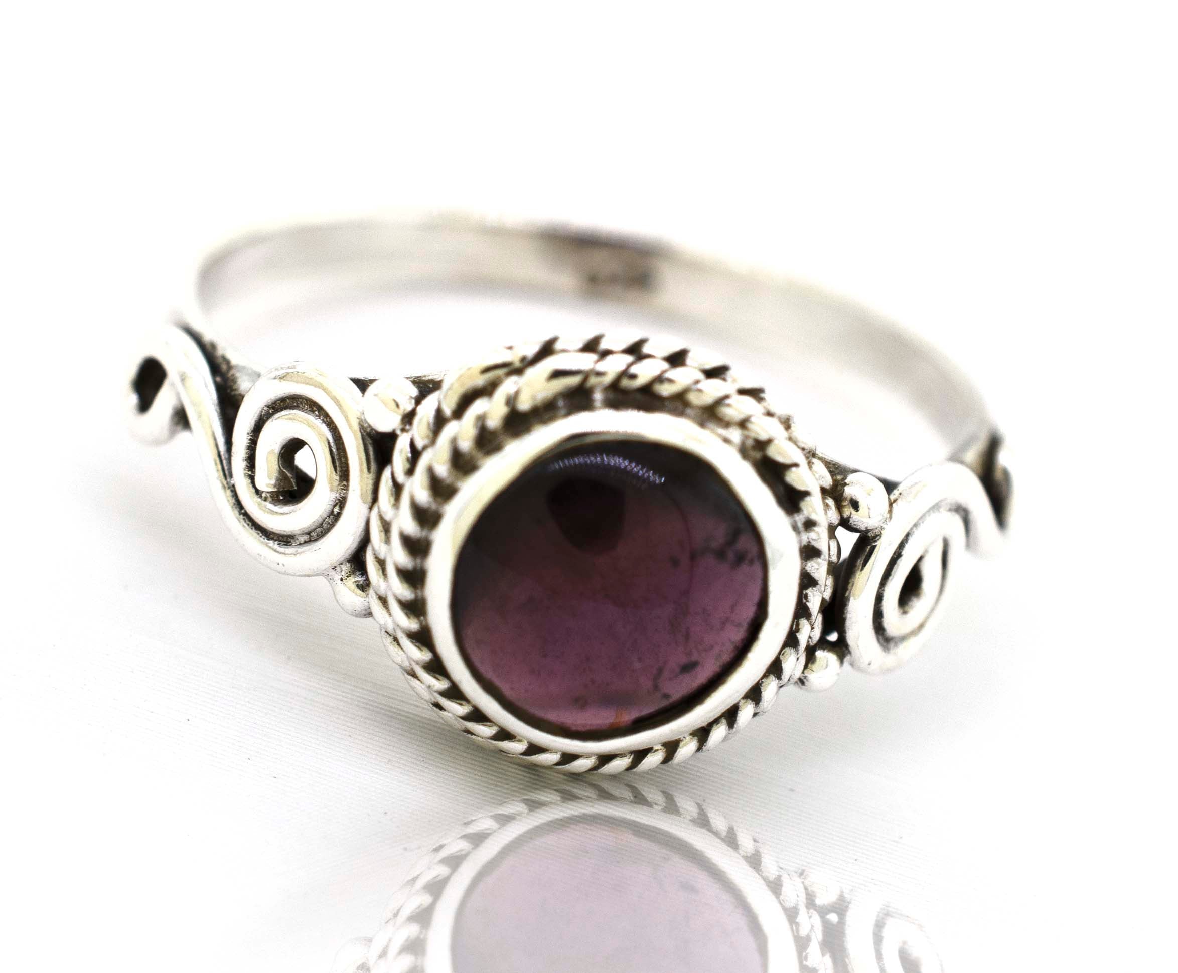 A bohemian-inspired Super Silver Gemstone Circle Ring With Rope Border And Swirl Design with a beautiful purple Gemstone Circle Ring With Rope Border And Swirl Design set in .925 sterling silver.