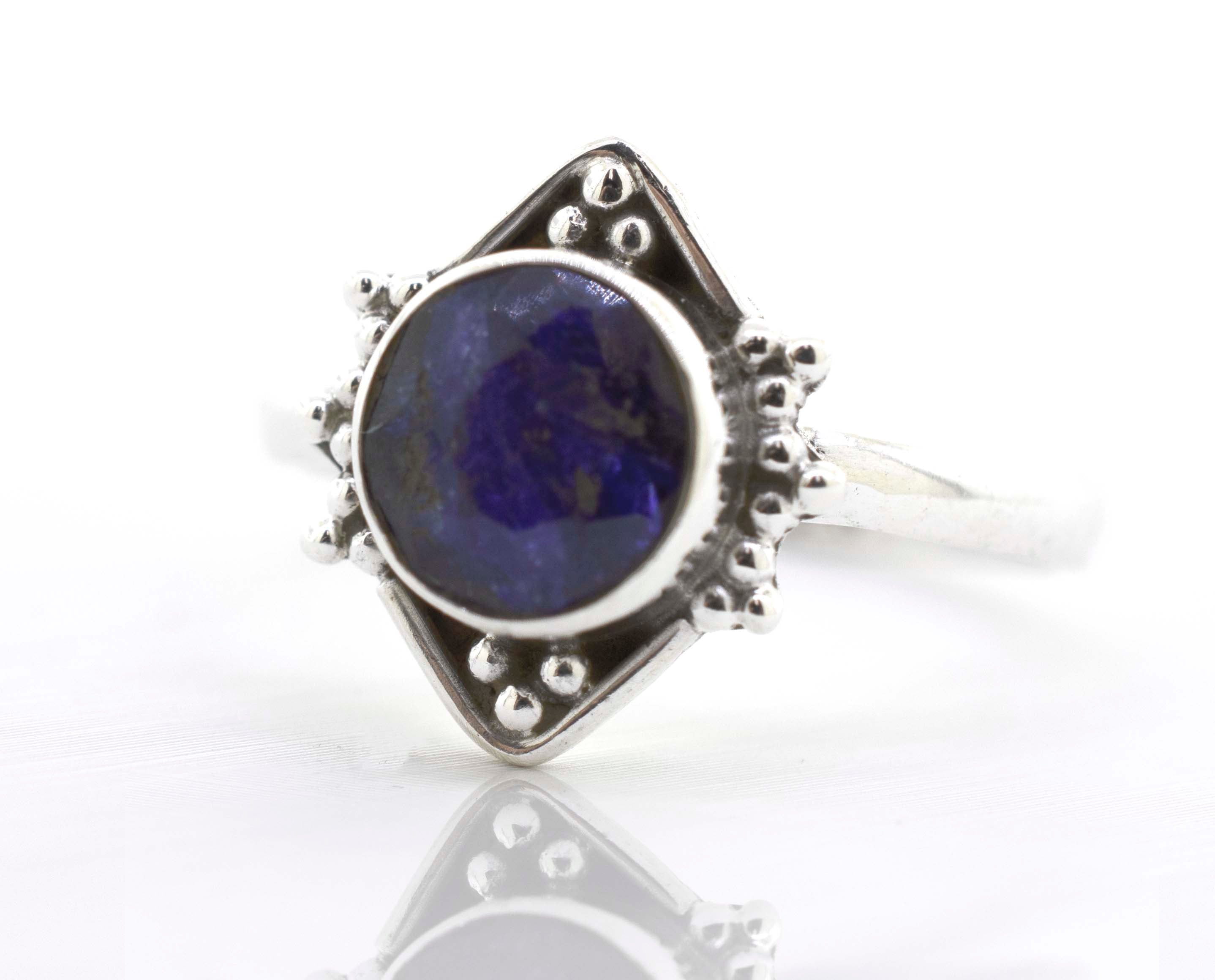 A Super Silver round gemstone ring with oxidized diamond shape pattern.