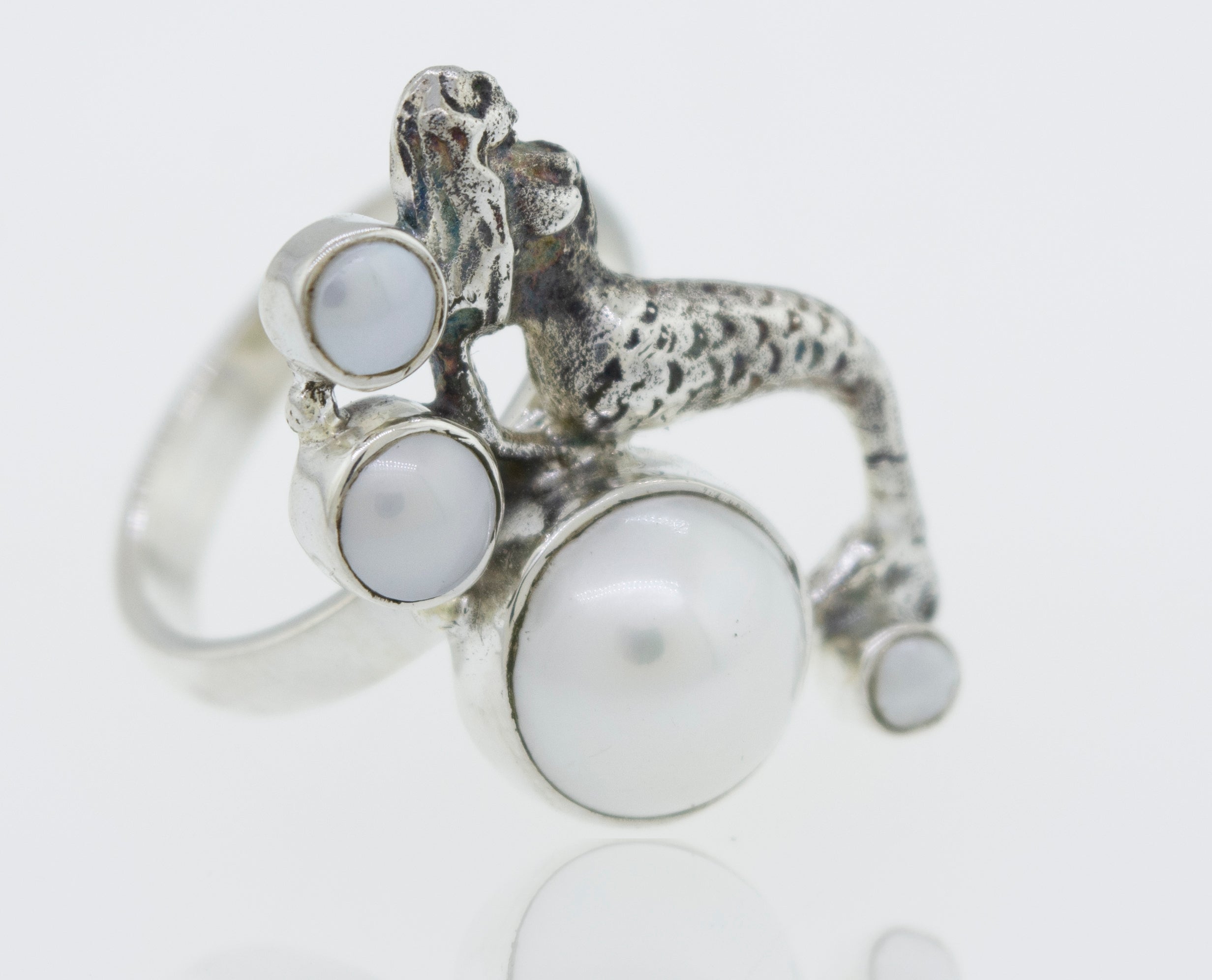 A Mermaid Ring with Pearl adorned with a mythical mermaid and delicate pearls.