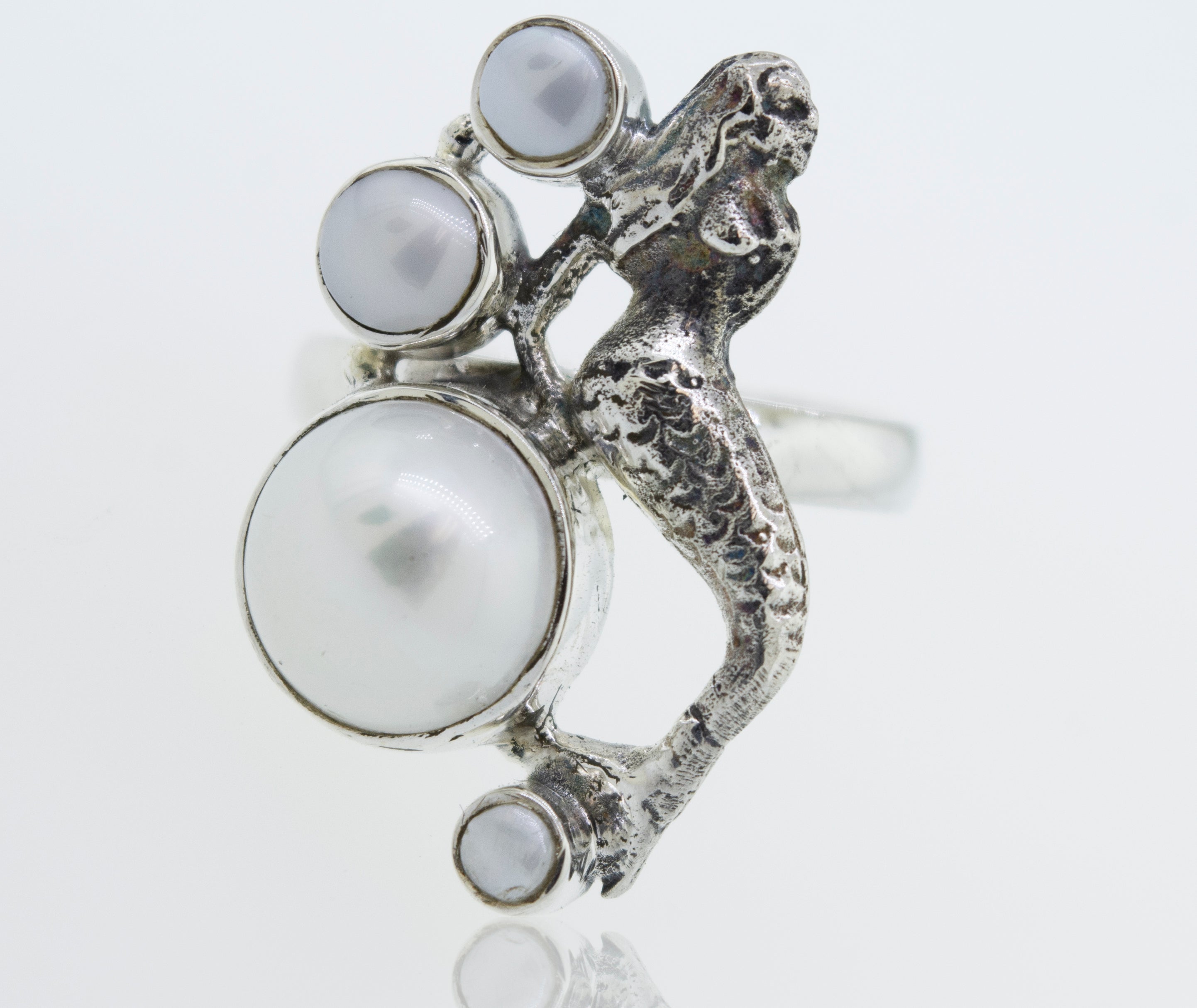 A Mermaid Ring with Pearl adorned with a mermaid and pearls, inspired by the enchanting depths of the ocean.