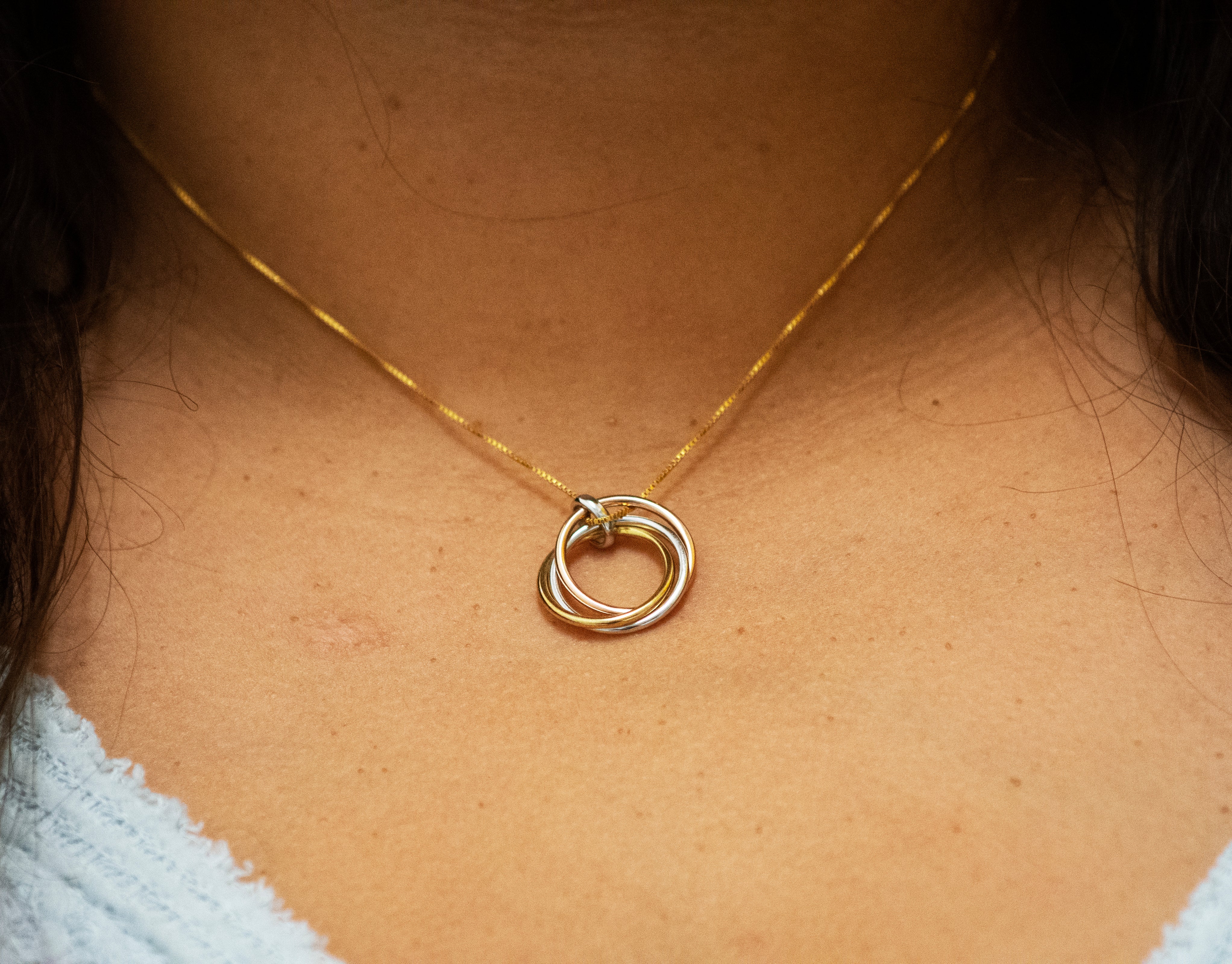 A woman's neck adorned with a Super Silver Simple and Elegant Gold and Rose Gold Plated Pendant necklace.