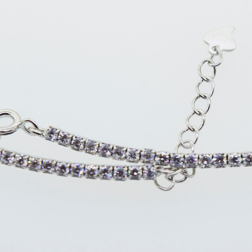 
                  
                    A Super Silver cubic zirconia tennis necklace with a chain.
                  
                