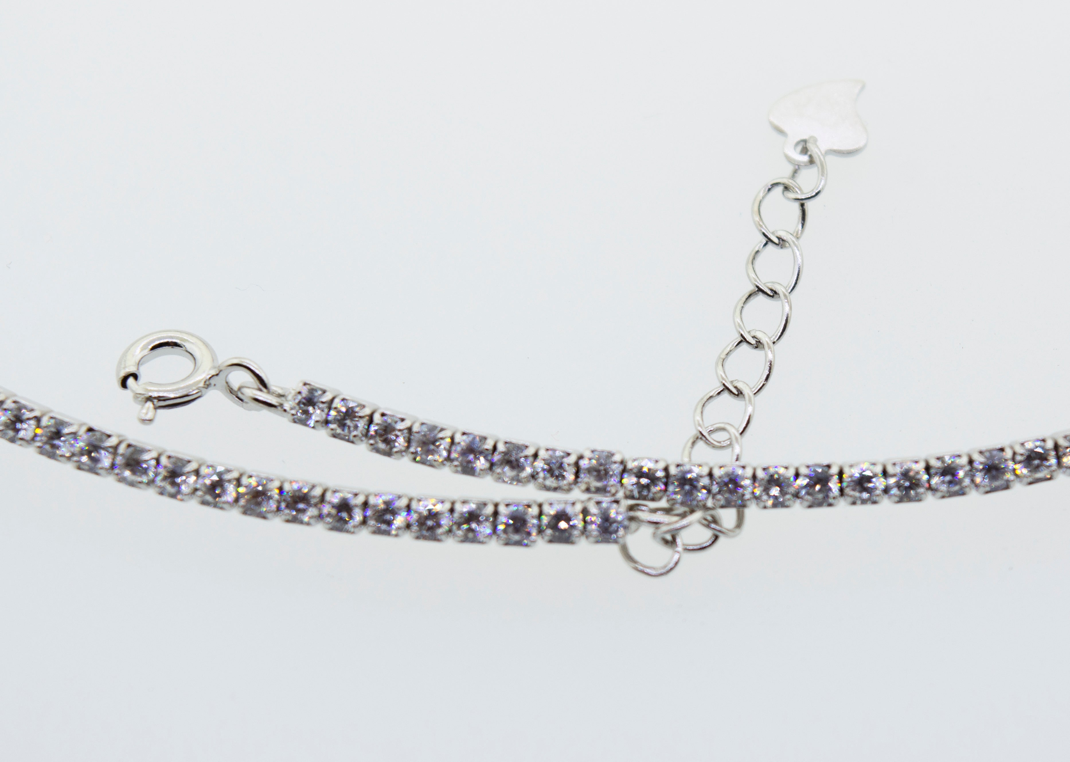 A Super Silver cubic zirconia tennis necklace with a chain.