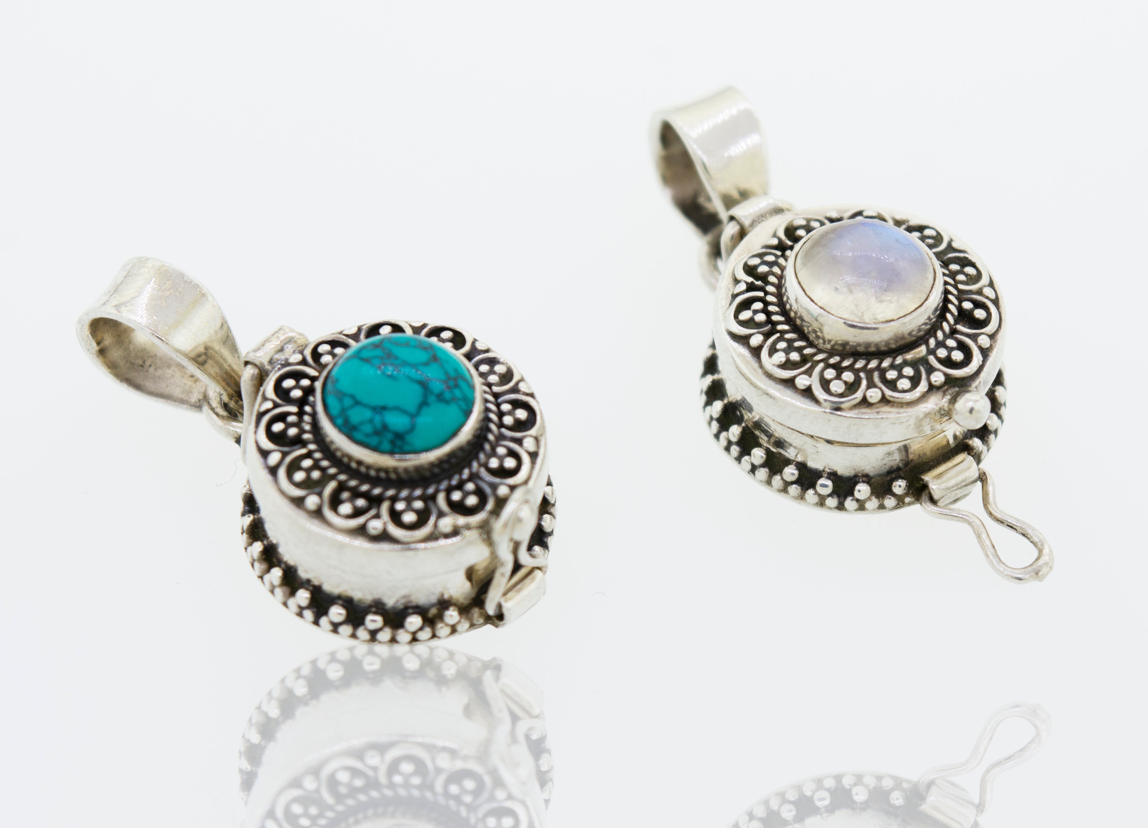 Two Super Silver Stone Poison Locket pendants on a white surface.