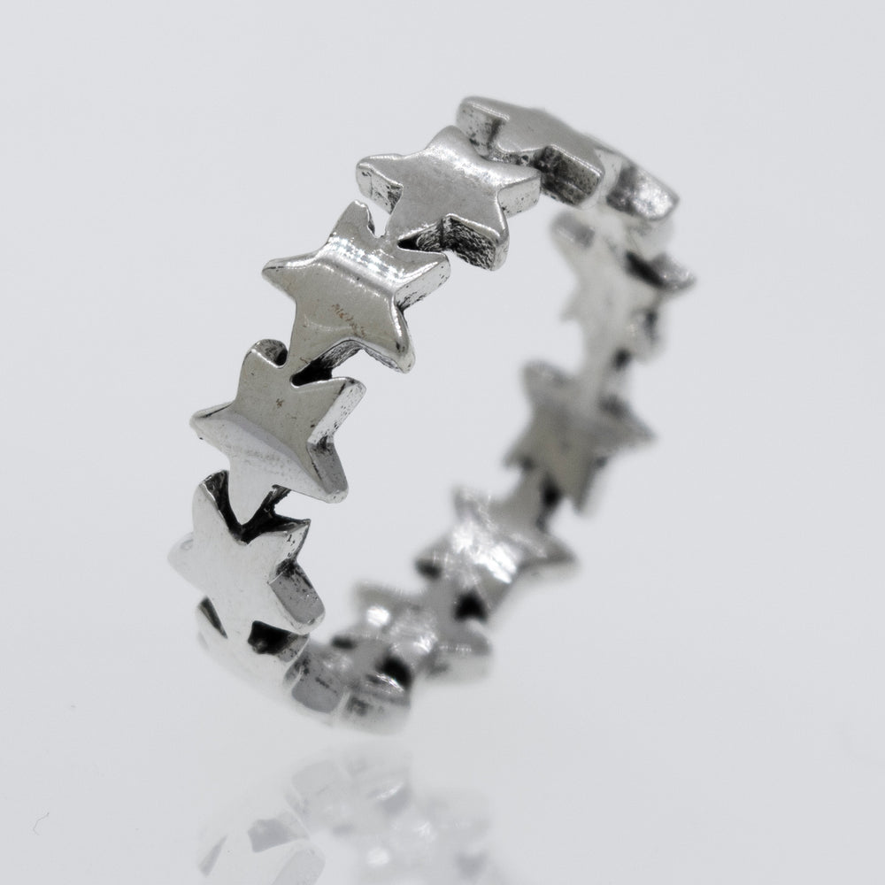 A Super Silver Star Pattern Ring on a white surface.